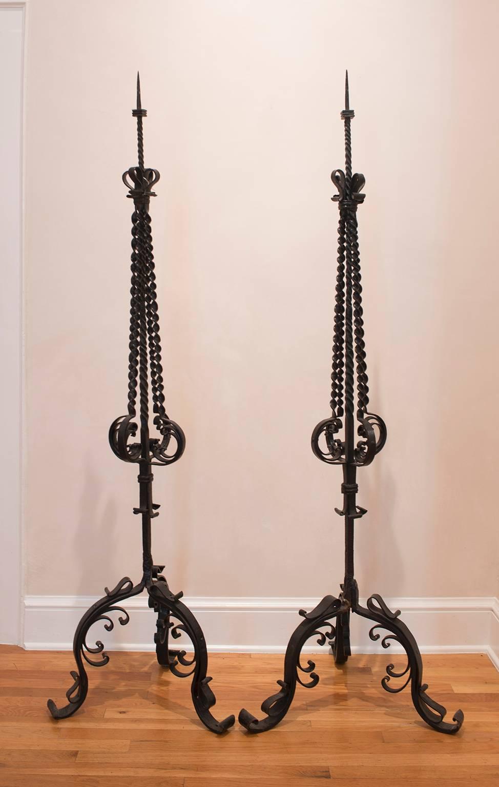 Hand-forged iron torchieres with elaborate ornamentation