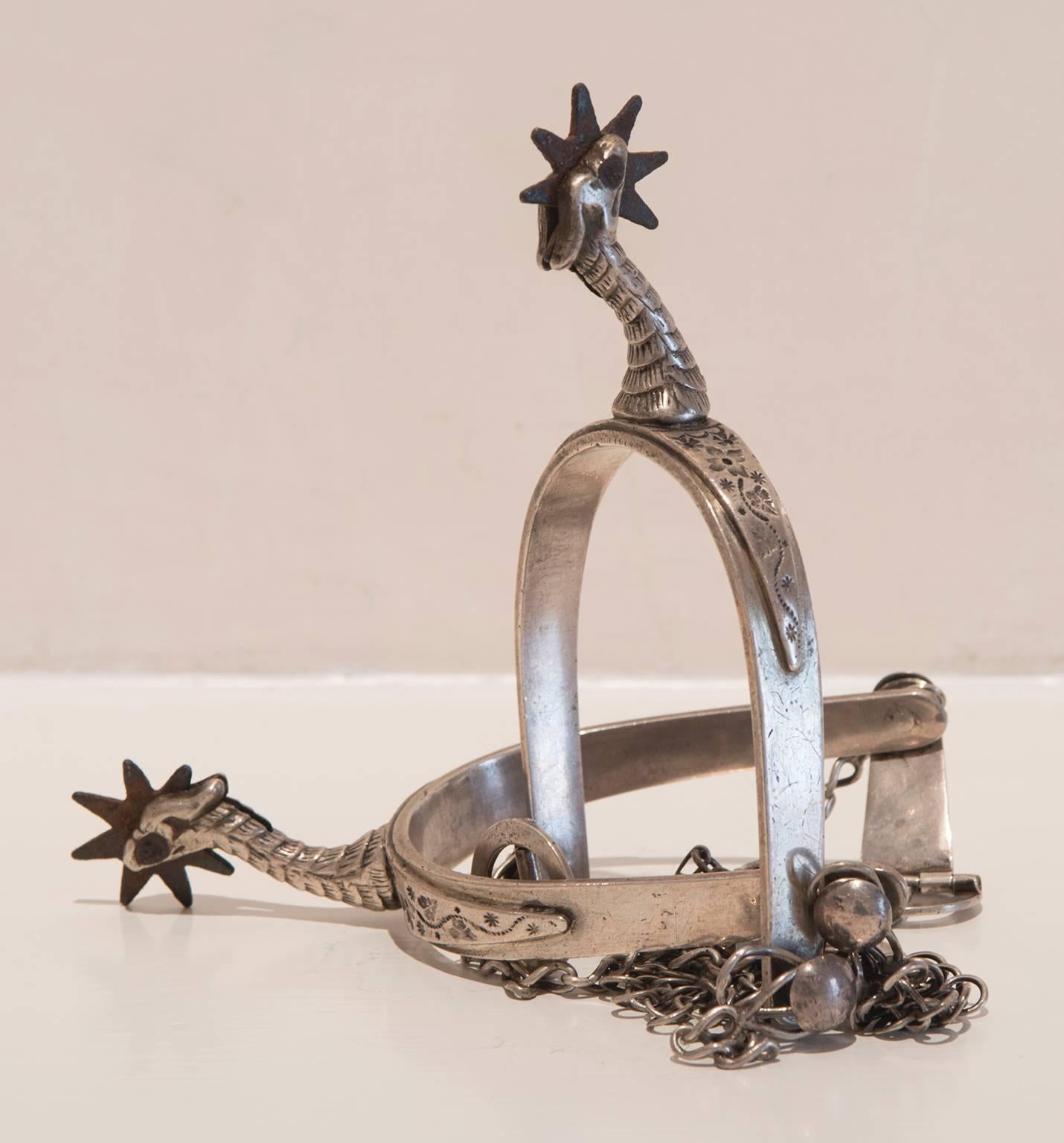 These Spanish Colonial silver spurs feature rooster heads and fine chain fasteners.