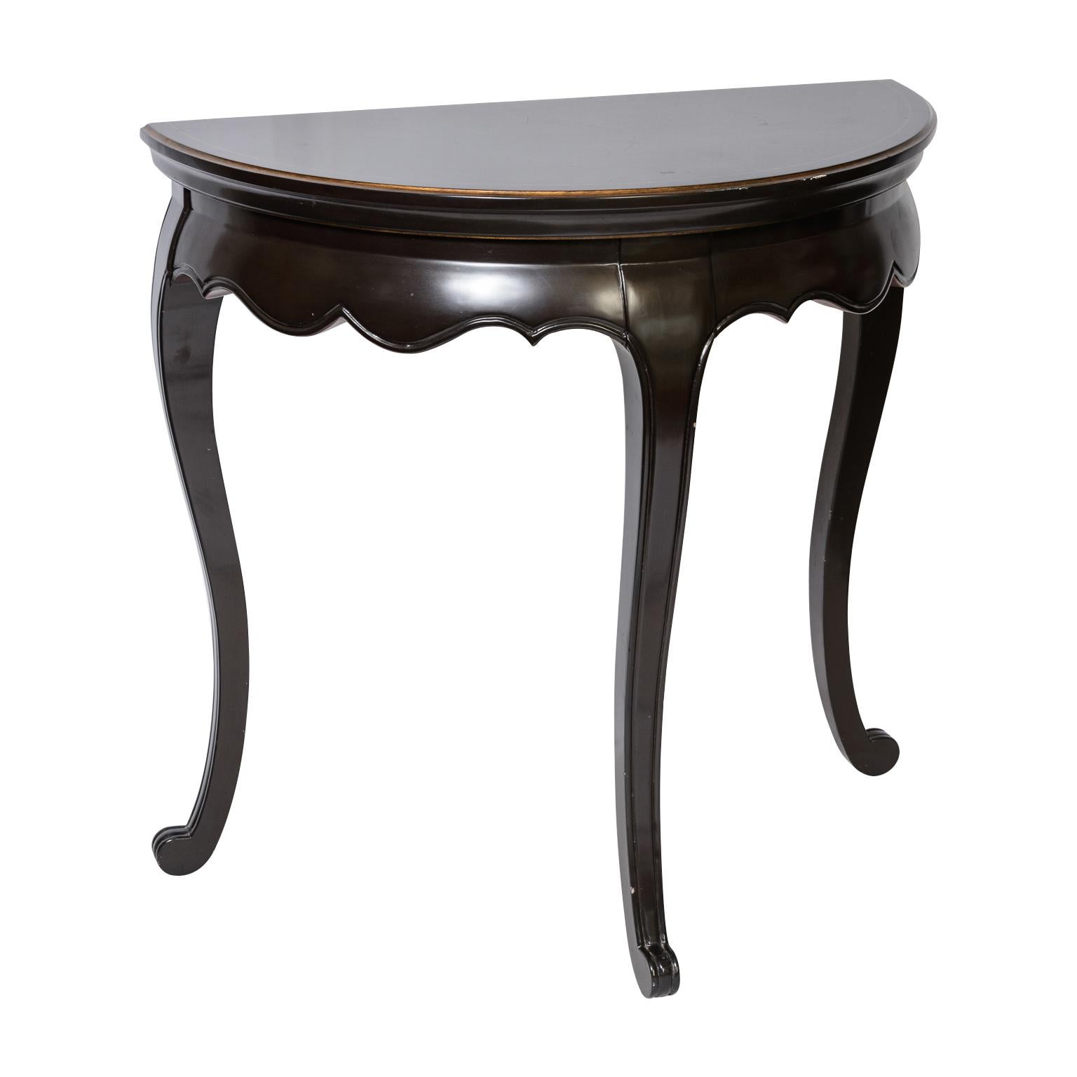 Just in,  in this Pair of Asian Style Black Lacquer Demi Lune Console Tables.
Great carved apron and three cabriole legs for each.
When put back to back they are a beautiful round table.
They are preowned and probably from the 80s.
Very good vintage