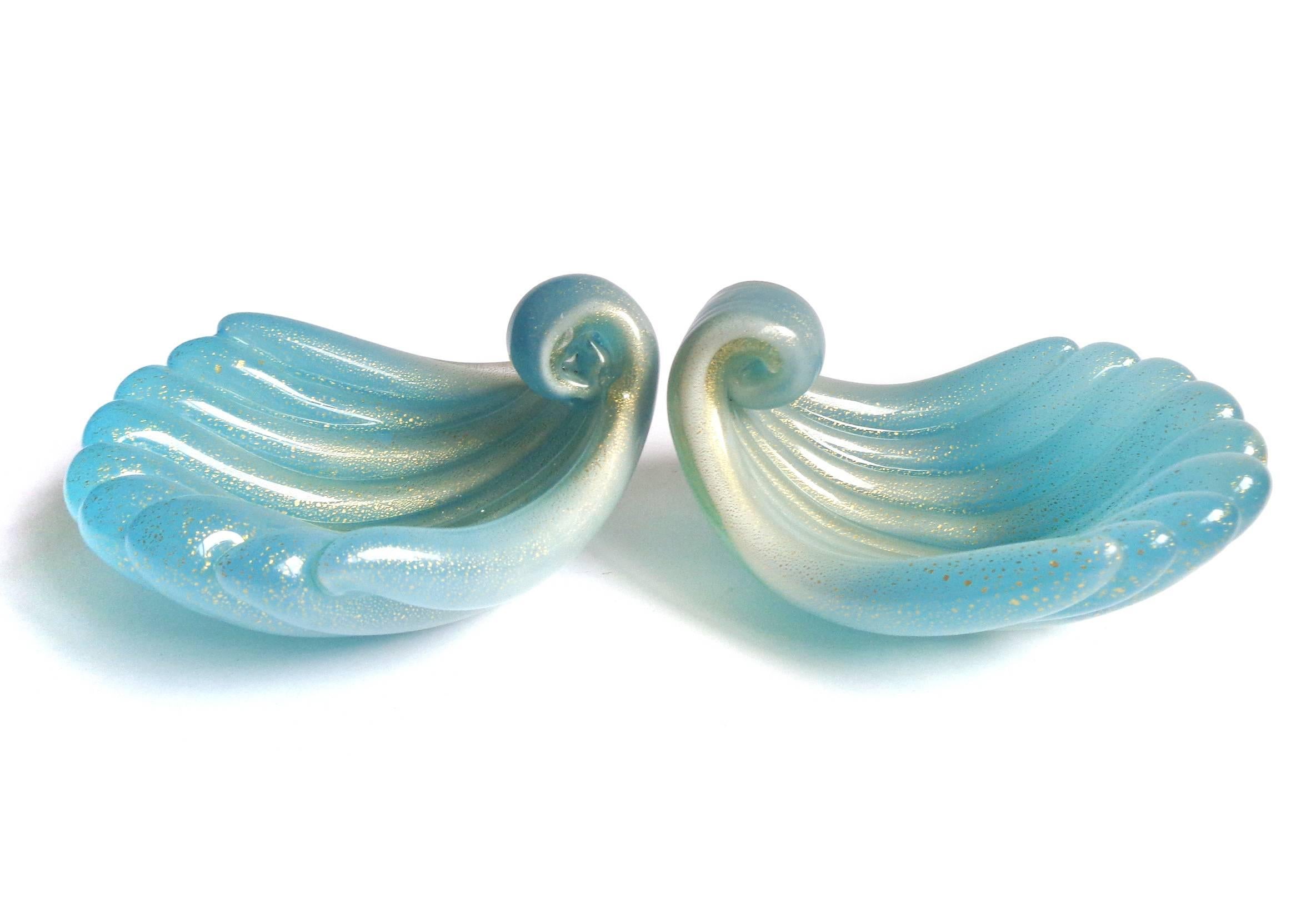 Free shipping worldwide! See details below description.

Gorgeous pair of Murano handblown opalescent blue and gold flecks art glass shell bowls. Documented to designer Archimede Seguso. Perfect for rings / earrings on any vanity or bedside table.