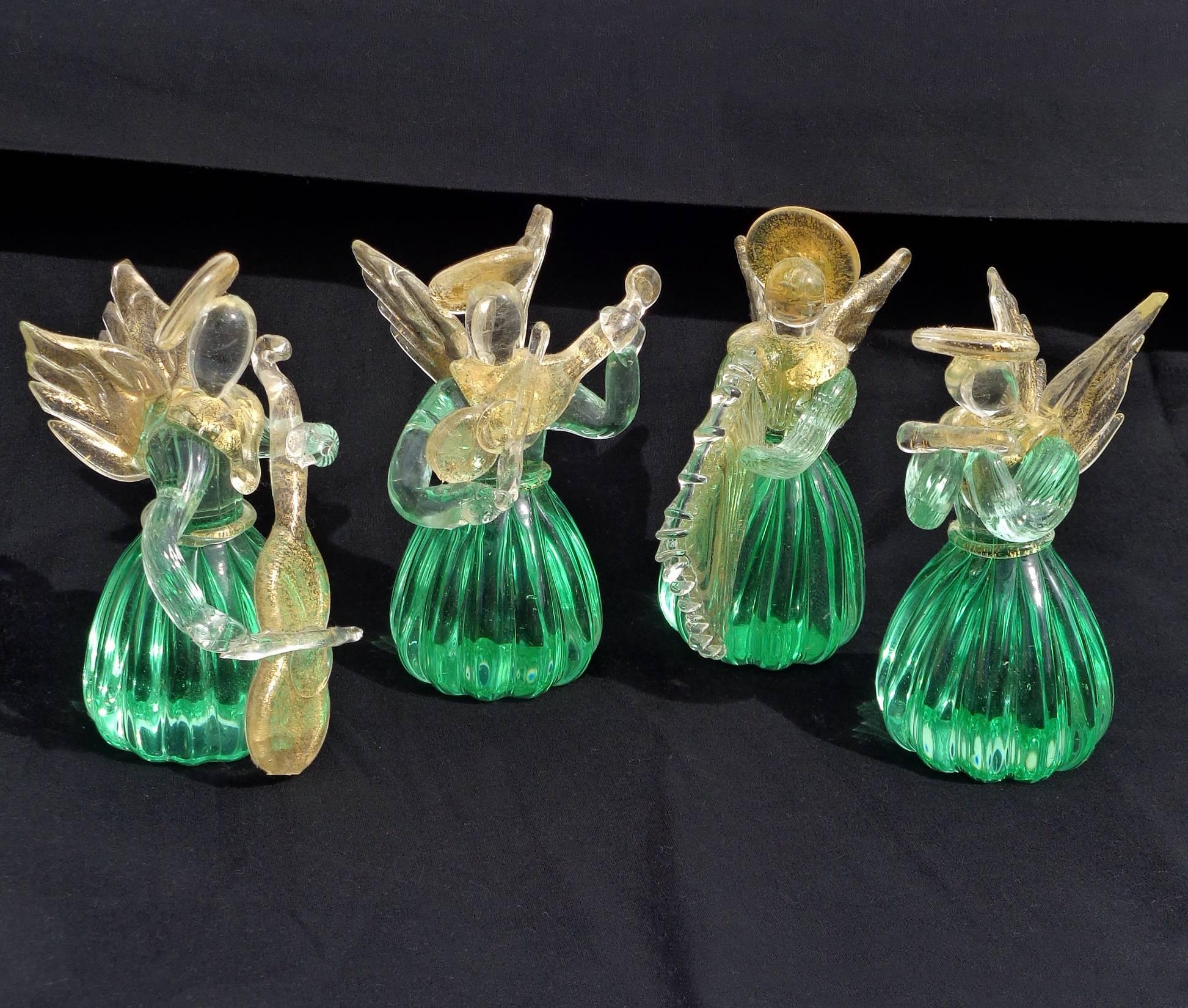 Free shipping worldwide! See details below description.

Very cute set of four Murano handblown green and gold flecks art glass angel musical quartet. Each angel has an instrument, bass, flute, violin and harp. Profusely covered in gold flecks,