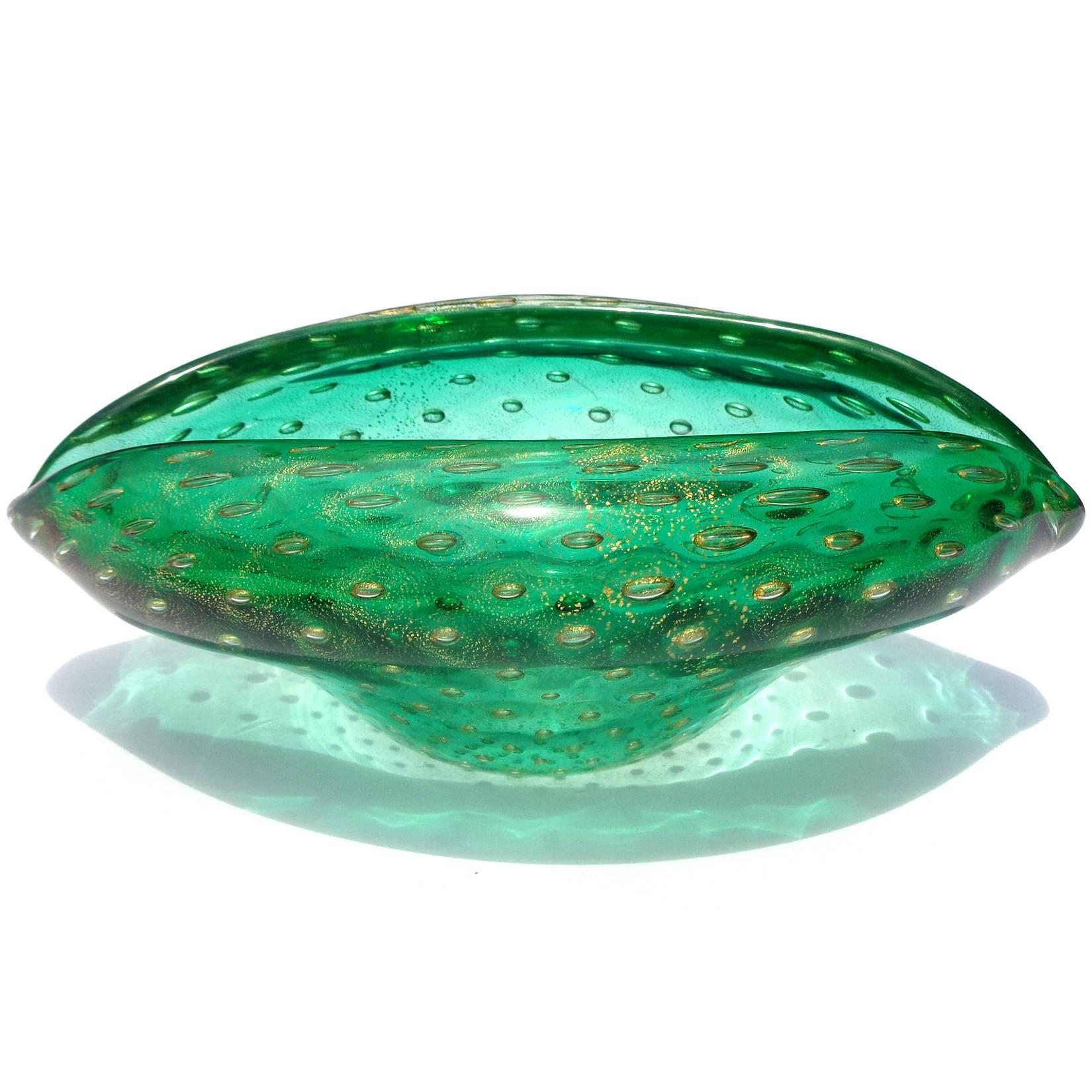 Unique Murano hand blown green and gold flecks art glass clam shell decorative bowl. Attributed to designer Archimede Seguso. The piece is done in "Bullicante" technique.
