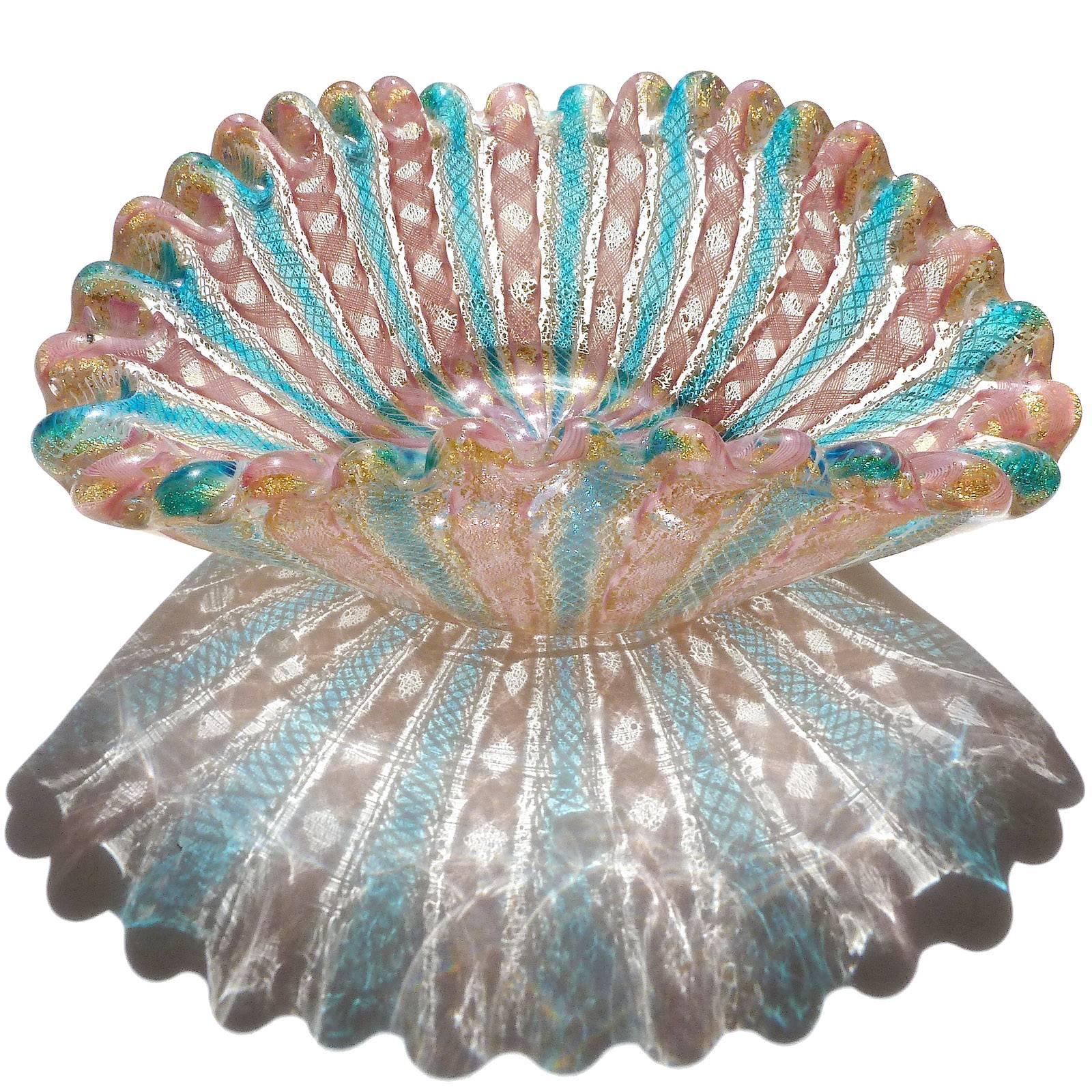 Beautiful Murano hand blown pink and blue Zanfirico ribbons and gold flecks art glass decorative bowl. Documented to the Fratelli Toso company. The piece has a scalloped rim, and profusely covered in gold leaf. Just look at the shadow it creates.