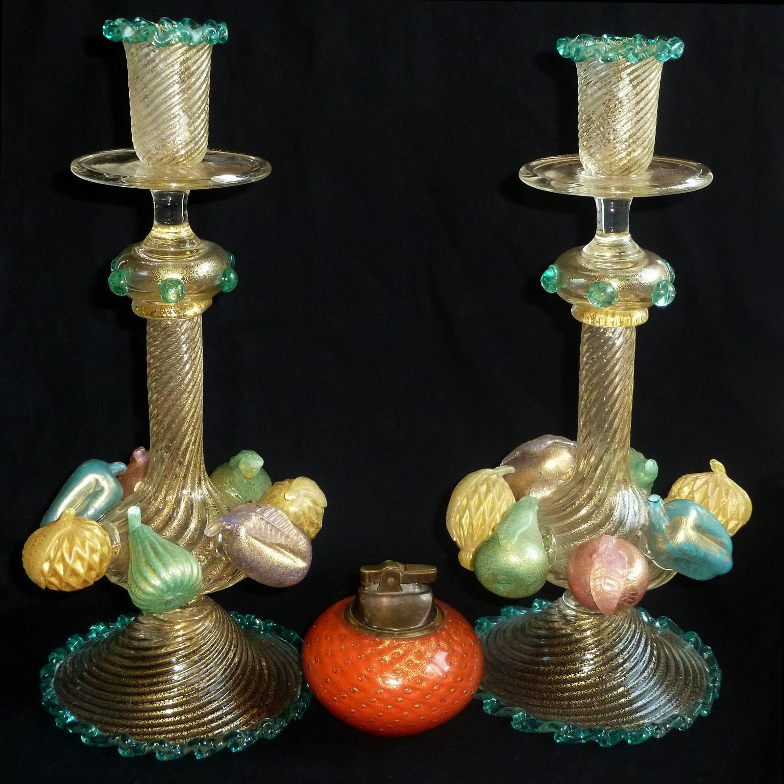 Very rare Murano hand blown fruit and gold leaf art glass candlesticks. Documented to master artist and designer Ercole Barovier, for Barovier e Toso, circa 1940s. There are seven applied fruit pieces to each, one pink apple, one green pear, one