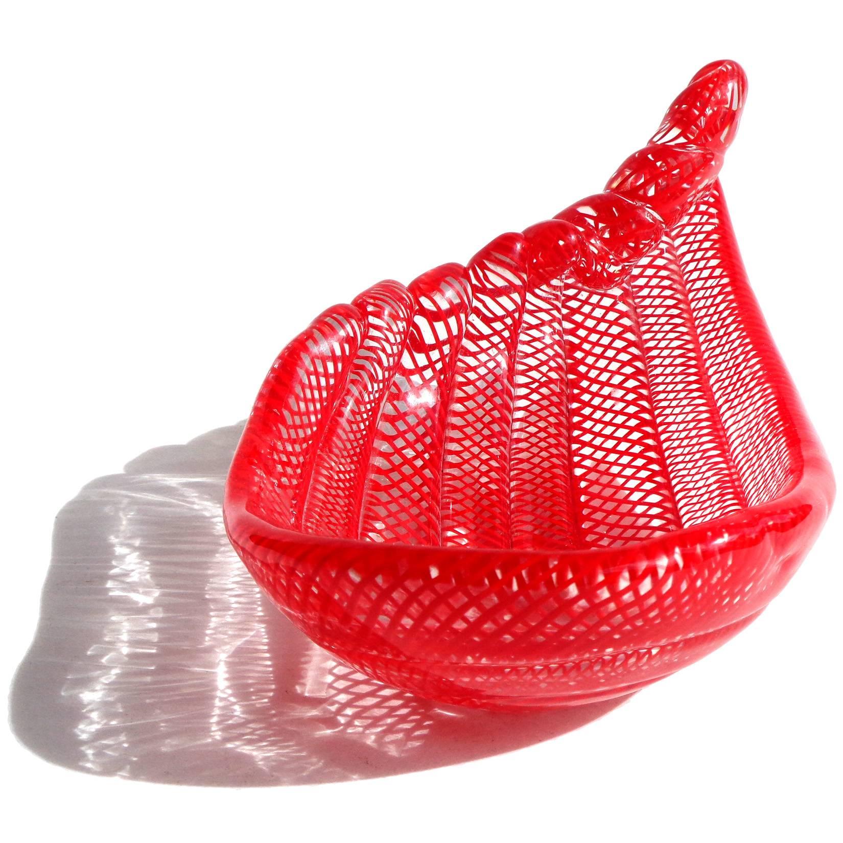 Gorgeous Murano hand blown bright red net ribbon design Italian art glass bowl/trinket dish. Made with large rods of glass looped around each other, with a scroll design at the top edge. Created in the manner of designer Dino Martens. Measures 7