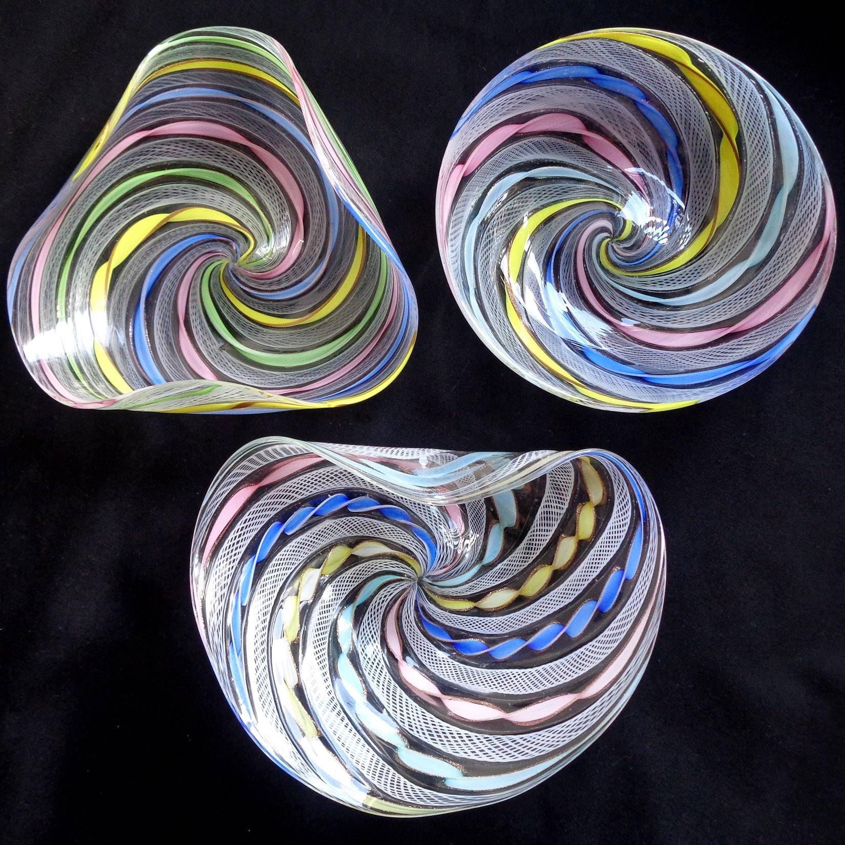 Beautiful set of three Murano hand blown rainbow Zanfirico and Latticino ribbons Italian art glass dishes. Created in the manner of the Salviati and Fratelli Toso companies. Each with intricate designed, and swirls of aventurine flecks in them.