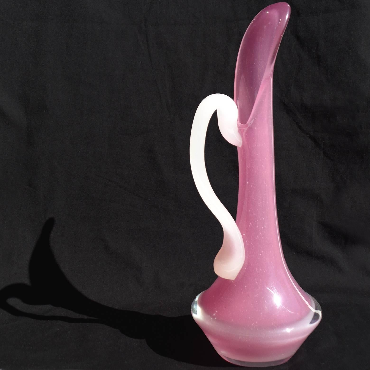 Beautiful Murano hand blown opal pink and white handle Italian art glass pitcher / ewer. Created in the manner of Archimede Seguso. Measures 11 inches tall.
