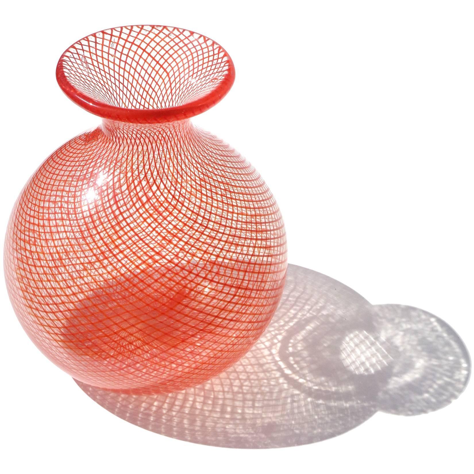 Beautiful Murano hand blown bright orange ribbons Italian art glass flower vase. Attributed to the Seguso Vetri d'Arte, circa 1960s, in "Filigrana Corallo", with similar vase published in their book. The ribbons create a diamond pattern