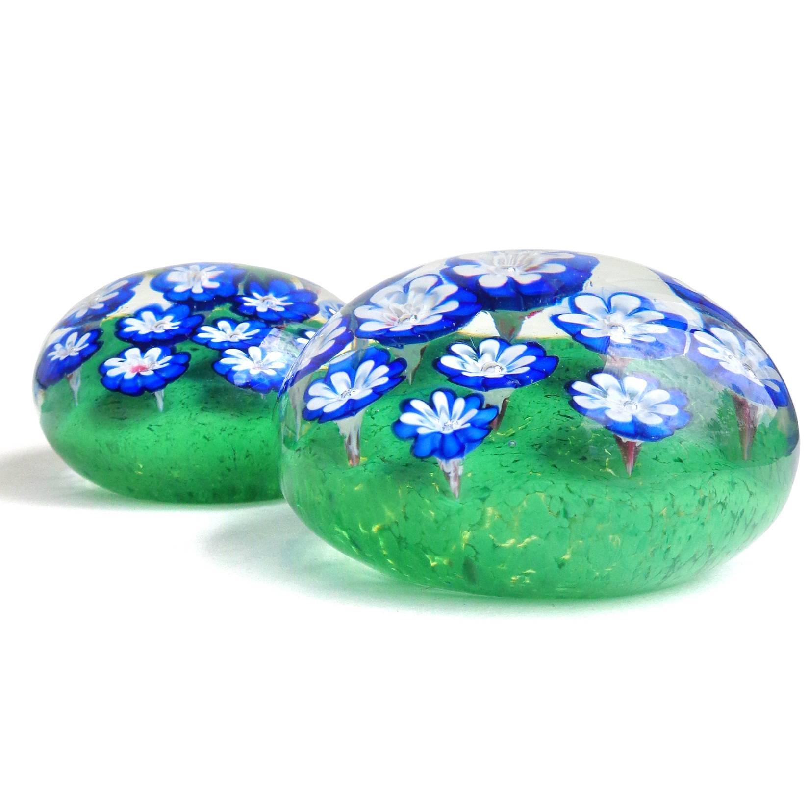 Gorgeous set of Murano hand blown blue and white millefiori Italian art glass flower garden paperweights. Attributed to designer Galliano Ferro. The flowers grow out of a bed of green, just beautiful! Large paperweight measures 3 1/2" across -