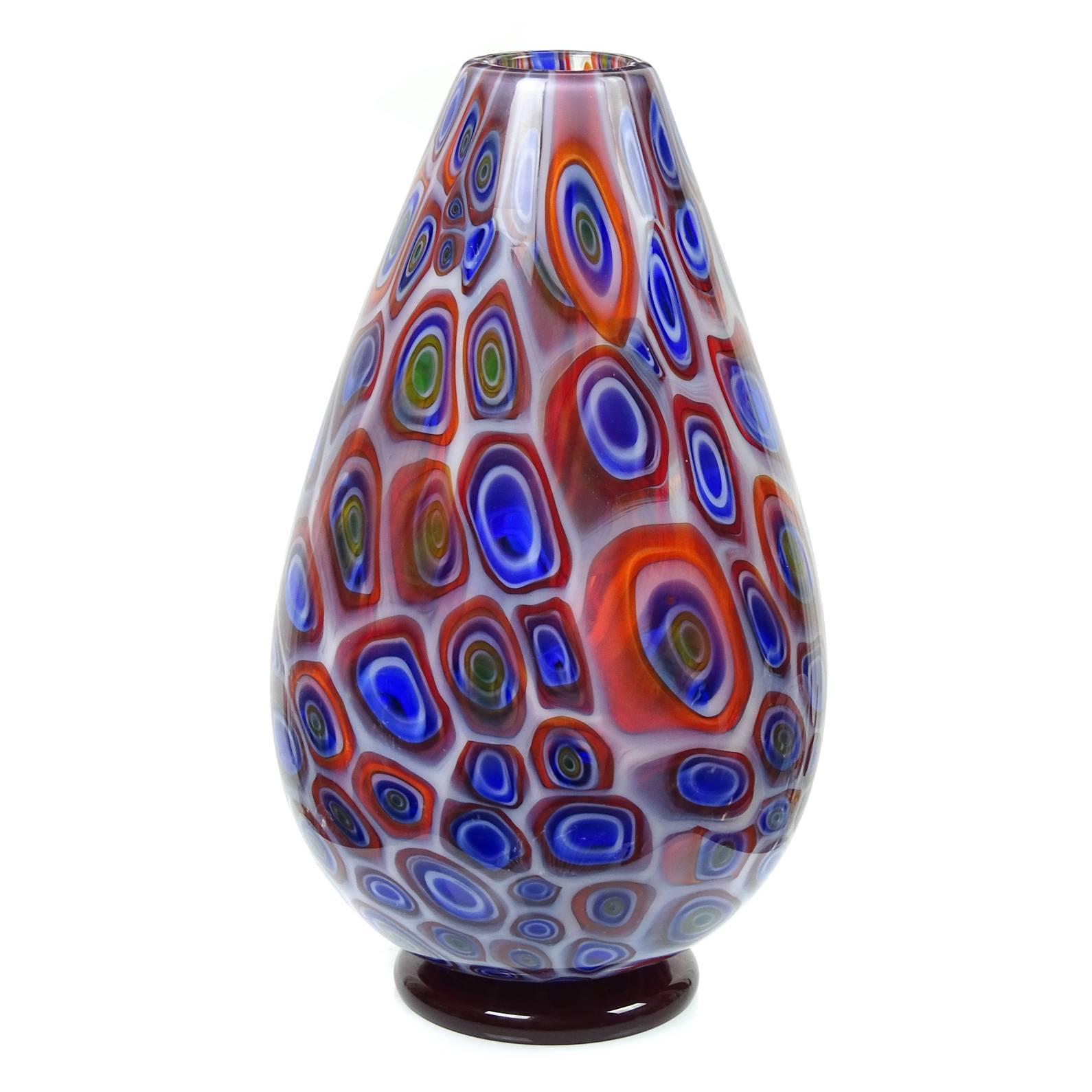 Very large Murano hand blown opalescent white, red, blue and orange "bullseye" murrines Italian art glass vase. The piece is signed Vistosi underneath. Stands on a red disk. The murrines are a bit subdued, but come to life once lights hit