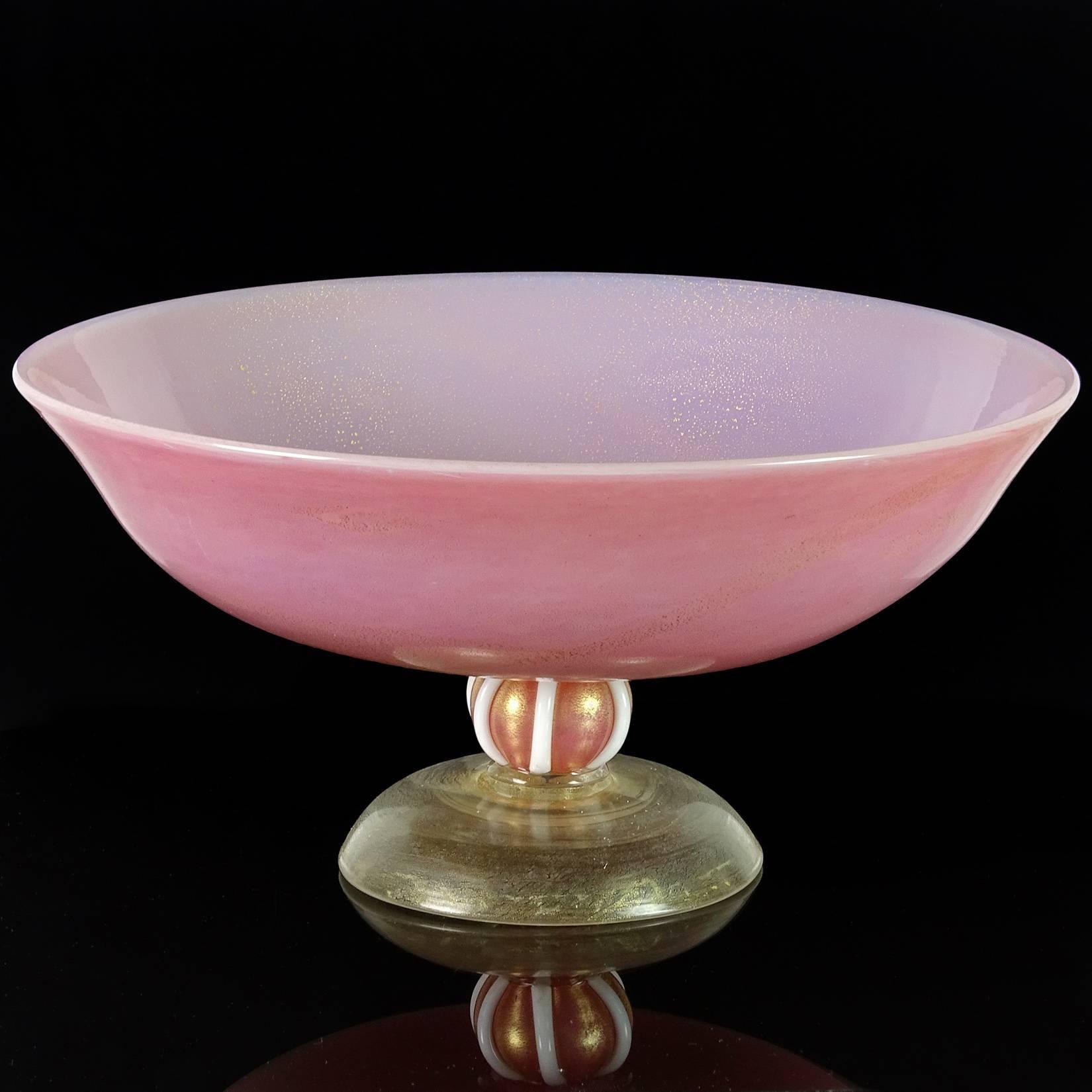 Free shipping worldwide! See details below description.

Gorgeous Murano handblown Incamiciato pink, opalescent and gold flecks art glass footed bowl. In the manner of designer Tomaso Buzzi. The bowl is profusely covered in gold leaf, with a ball