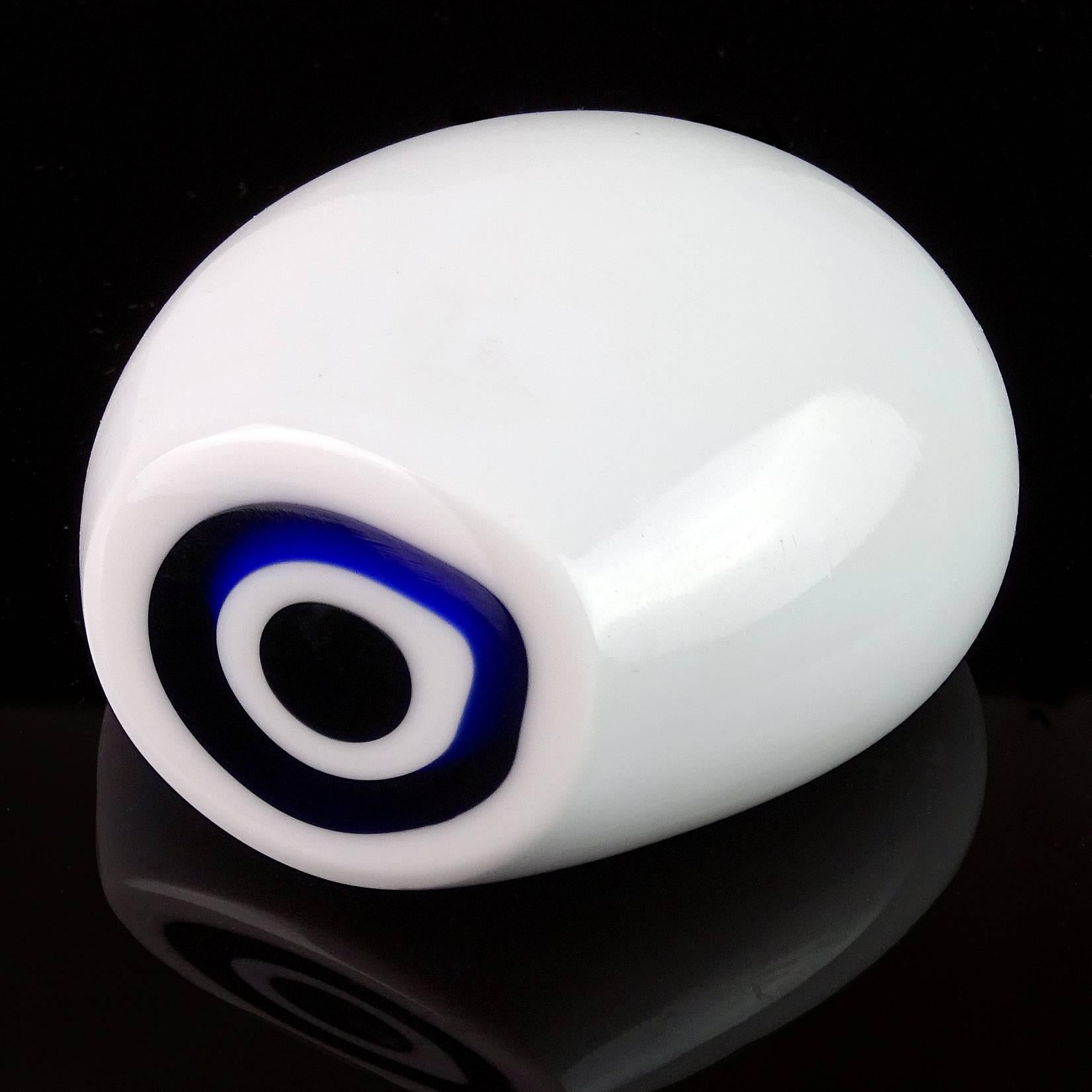 Rare Murano hand blown white, blue and black Italian art glass bullseye paperweight. Documented to the Vistosi company. The piece is made to look like a cut geode rock, with 4 layers of glass. Measures 3 1/4" long x 2" high. 

