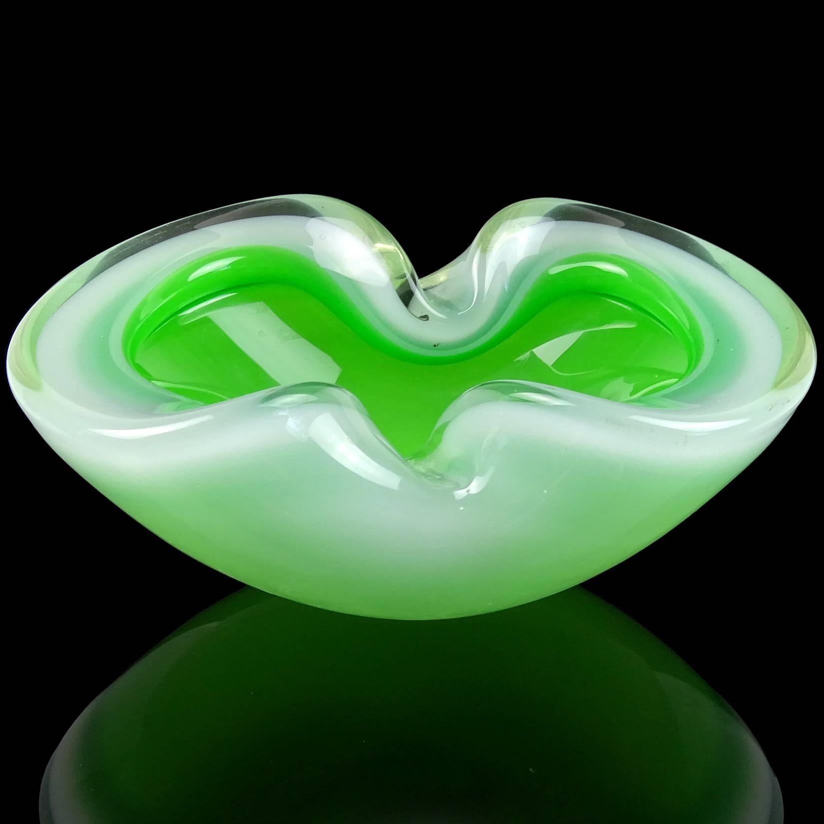 Beautiful Murano hand blown green and opal white Italian art glass decorative bowl / ashtray. It has two indents on the rim. Measures 6 1/2"long. 
