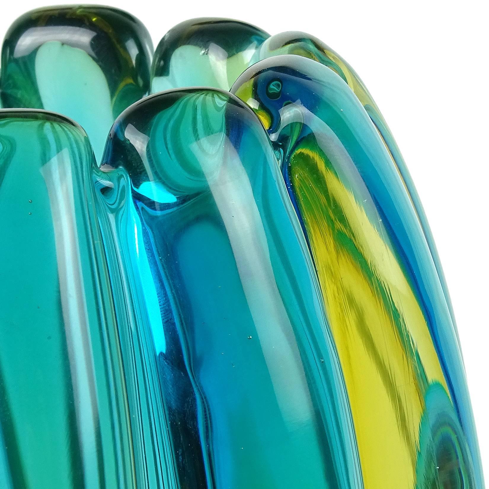 Free shipping worldwide! See details below description.

Beautiful Murano hand blown Sommerso blue, green and yellow art glass ribbed flower vase. Documented to designer Alfredo Barbini. Very thick piece with beautiful shape. Measures 9
