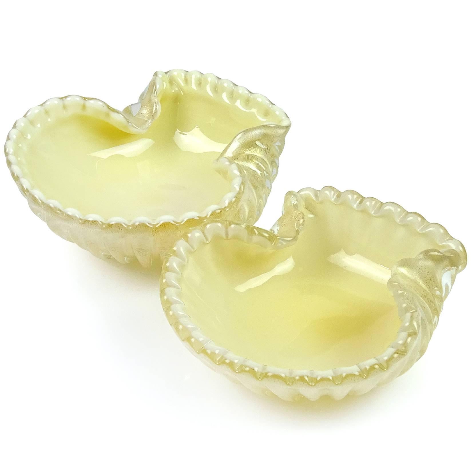 Beautiful Murano hand blown gold flecks over white, and creamy yellow art glass ribbed seashell bowls. Attributed to designer Archimede Seguso. They are profusely covered in gold leaf. Priced as a set, but can be sold separately. They measure 5 3/4