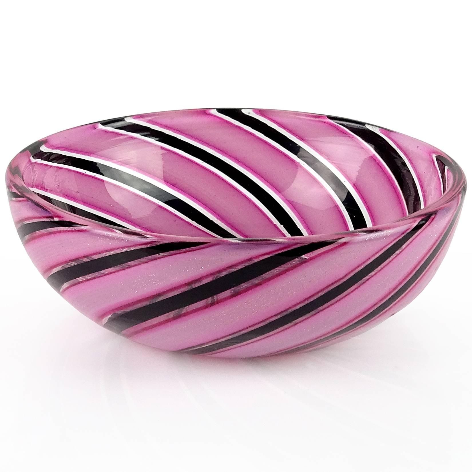 Beautiful Murano hand blown pink, black and aventurine stripes Italian art glass decorative bowl. Attributed to designer Dino Martens for Aureliano Toso. Each of the pink ribbons have thin lines of copper aventurine flecks. Great jewelry / ring