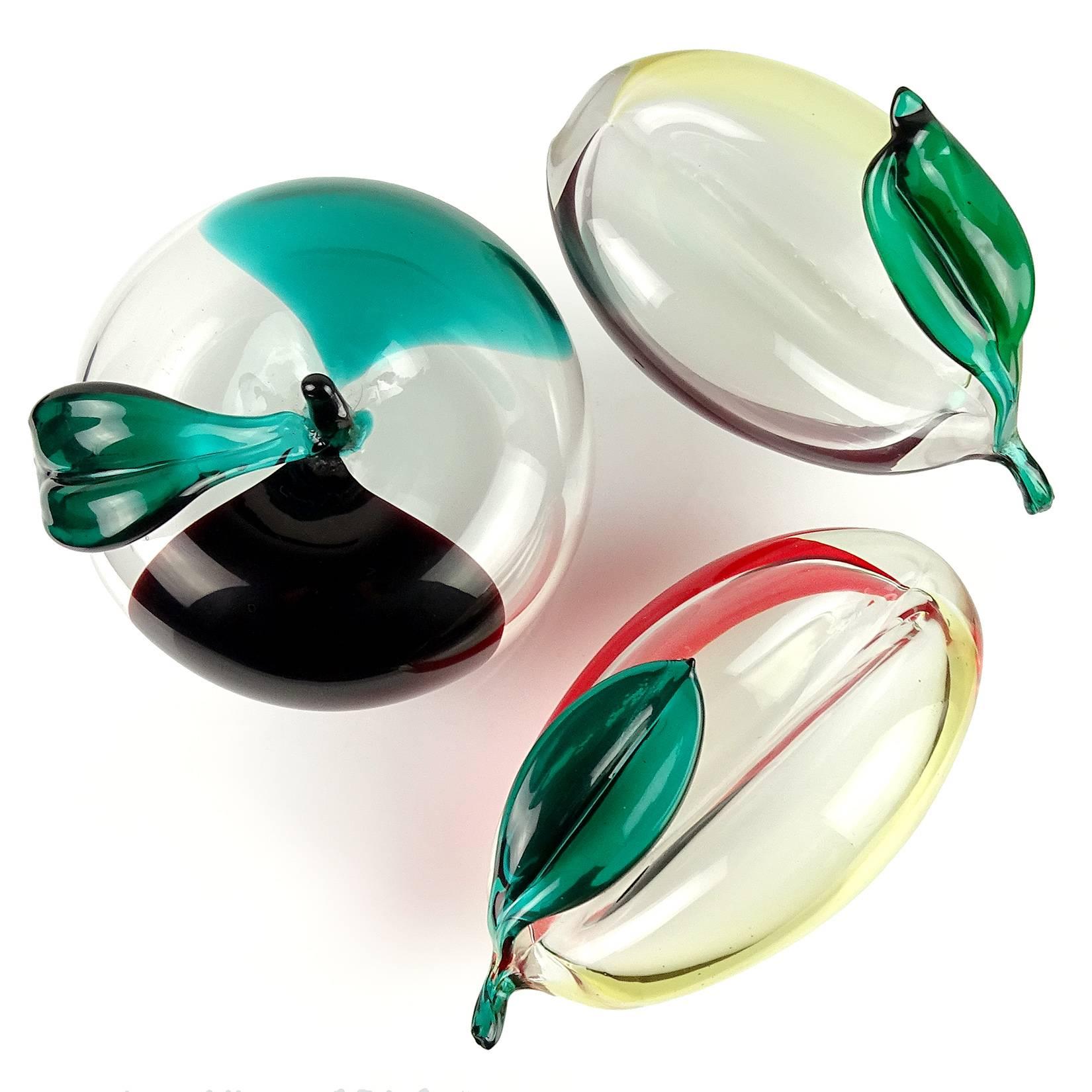 Gorgeous set of Murano hand blown black, green, red, yellow Italian art glass fruit sculptures. Documented to designer Fulvio Bianconi for Venini. There is an apple, and 2 other fruit pieces, with applied leafs in the "Macchie" design. One