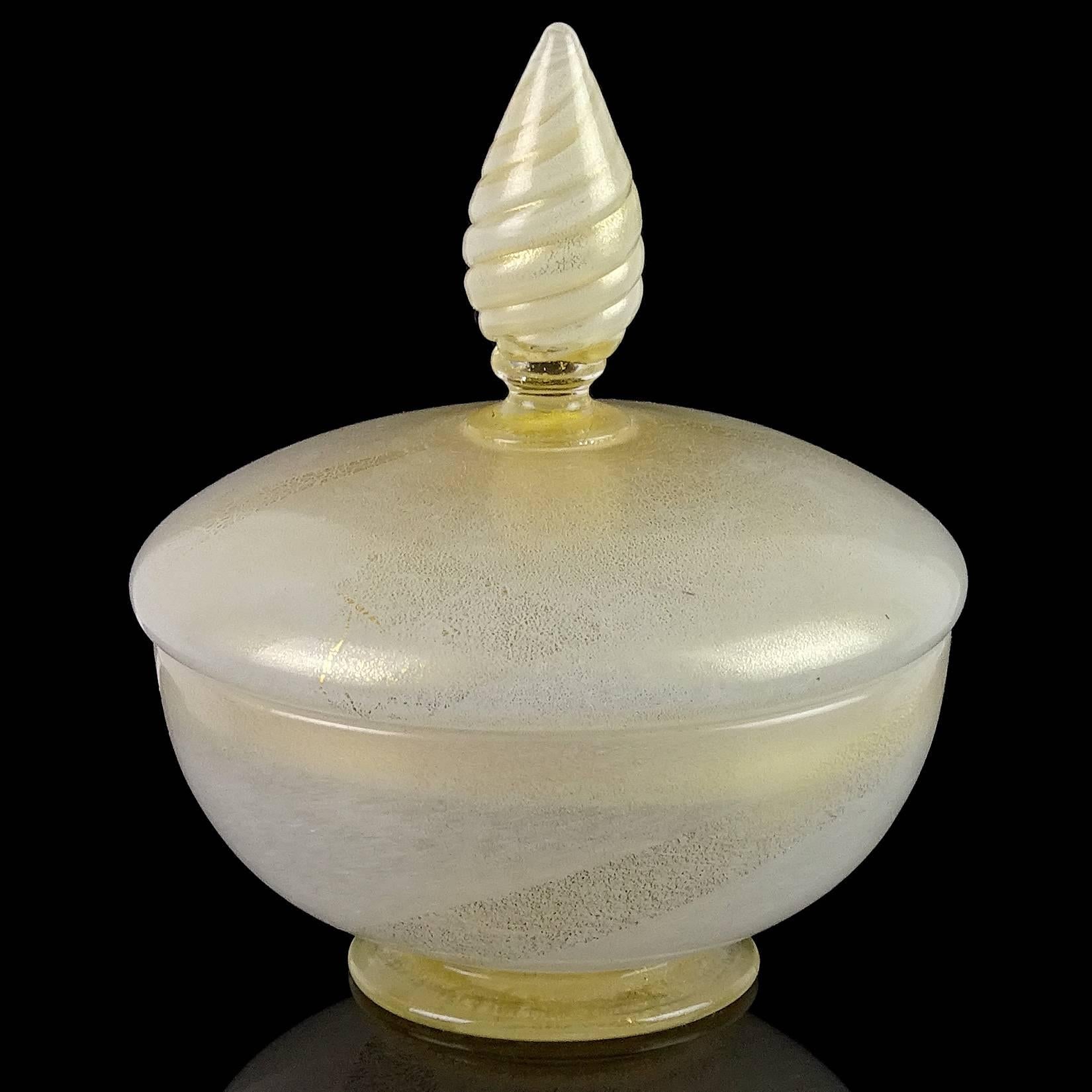 Elegant Murano hand blown white and gold flecks Italian art glass vanity powder / jewelry box. Documented to the Barovier e Toso company. Created with small dots of white pigments and profusely covered in gold leaf. Measures 6” high x 5” across.
