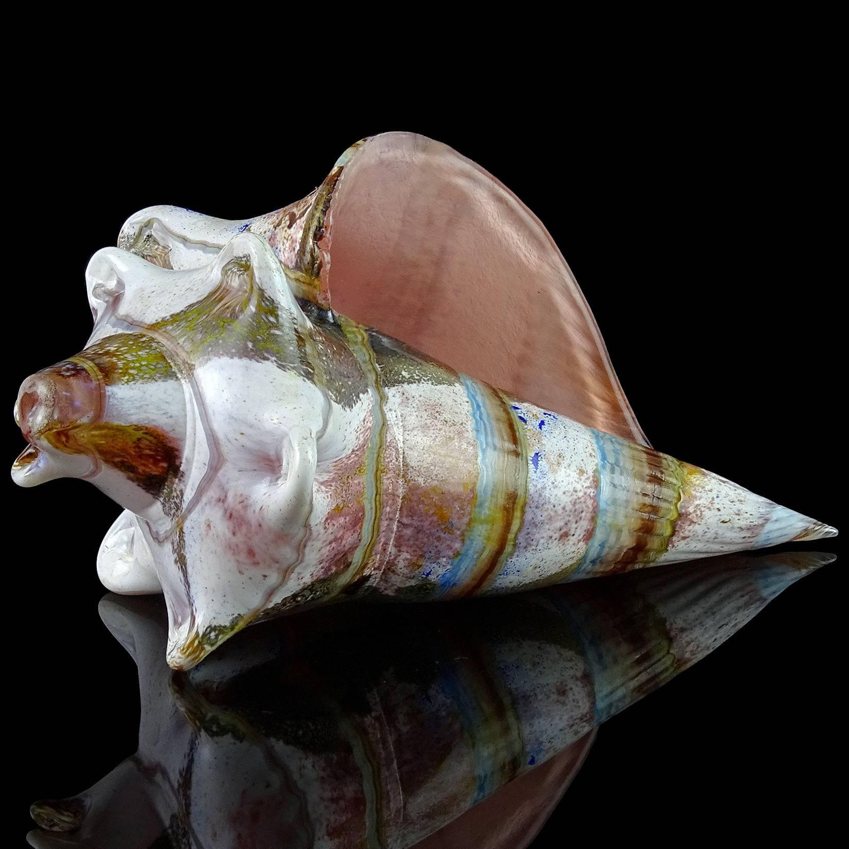 Gorgeous hand blown realistic multicolor Italian art glass conch shell sculpture. Unsigned. Very well detailed, looks like a true natural specimen. It has a soft pink interior, with blue, yellow, white, maroon and light sand colors. The seashell