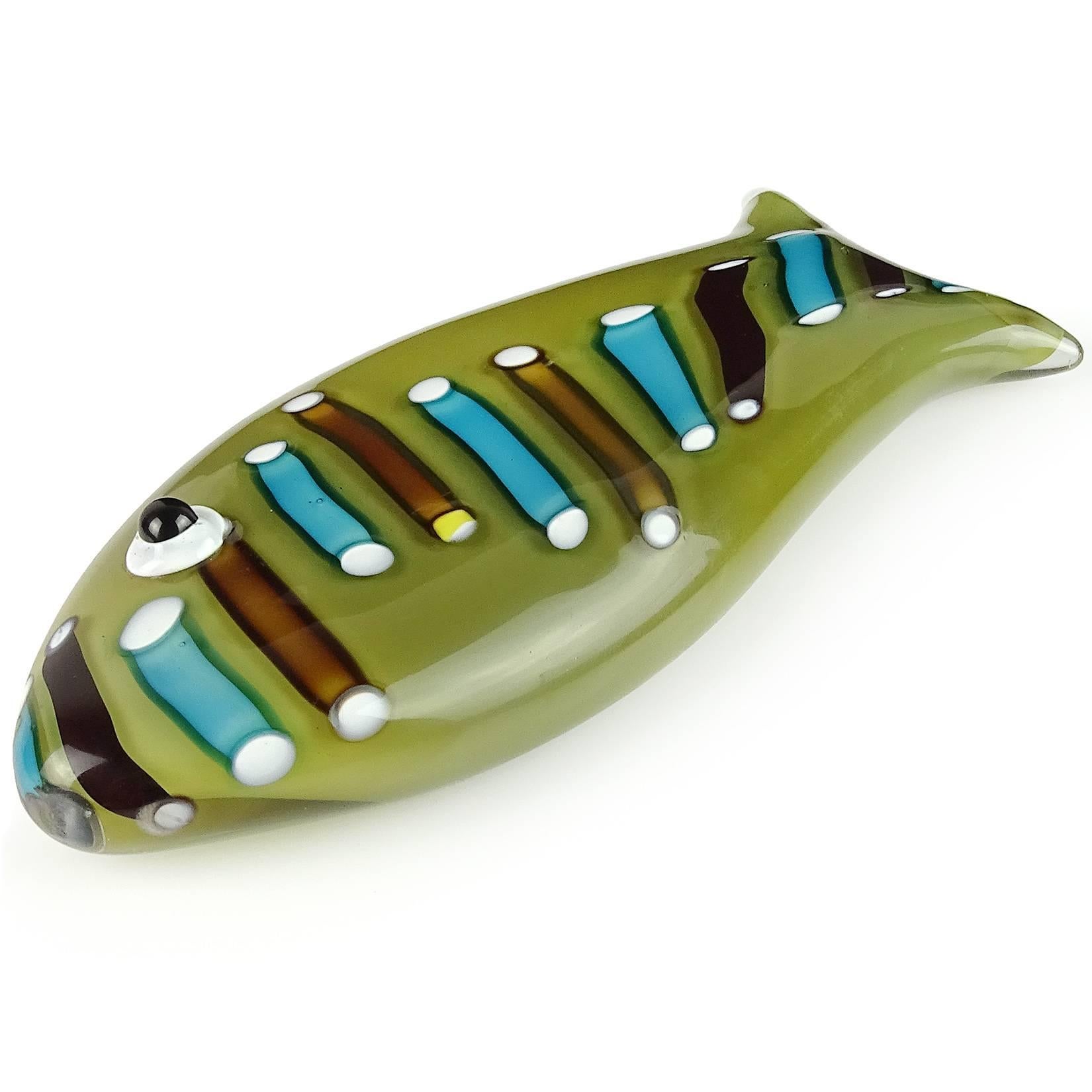 Cute and unusual Murano hand blown olive green with cut murine cane pieces Italian art glass fish sculpture / paperweight. Attributed to designer Ken Scott for Venini, circa 1950s. The fish looks to be unsigned. Measures 6 3/4” long. Last photo