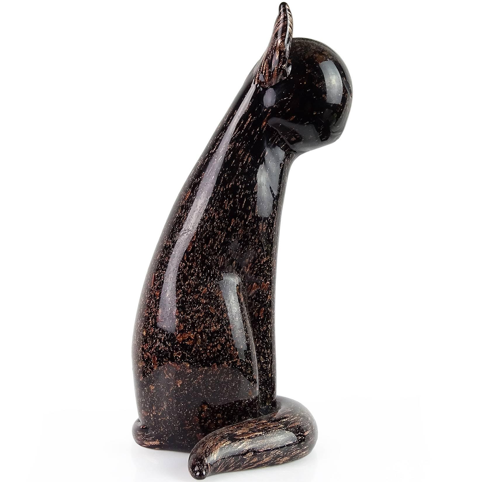 Gorgeous Murano hand blown jet black with copper aventurine flecks Italian art glass cat sculpture. Documented to designer Archimede Seguso. Still retains original, and intact red and gold “Made In Italy” label. Very elegant shape, with cut eyes.