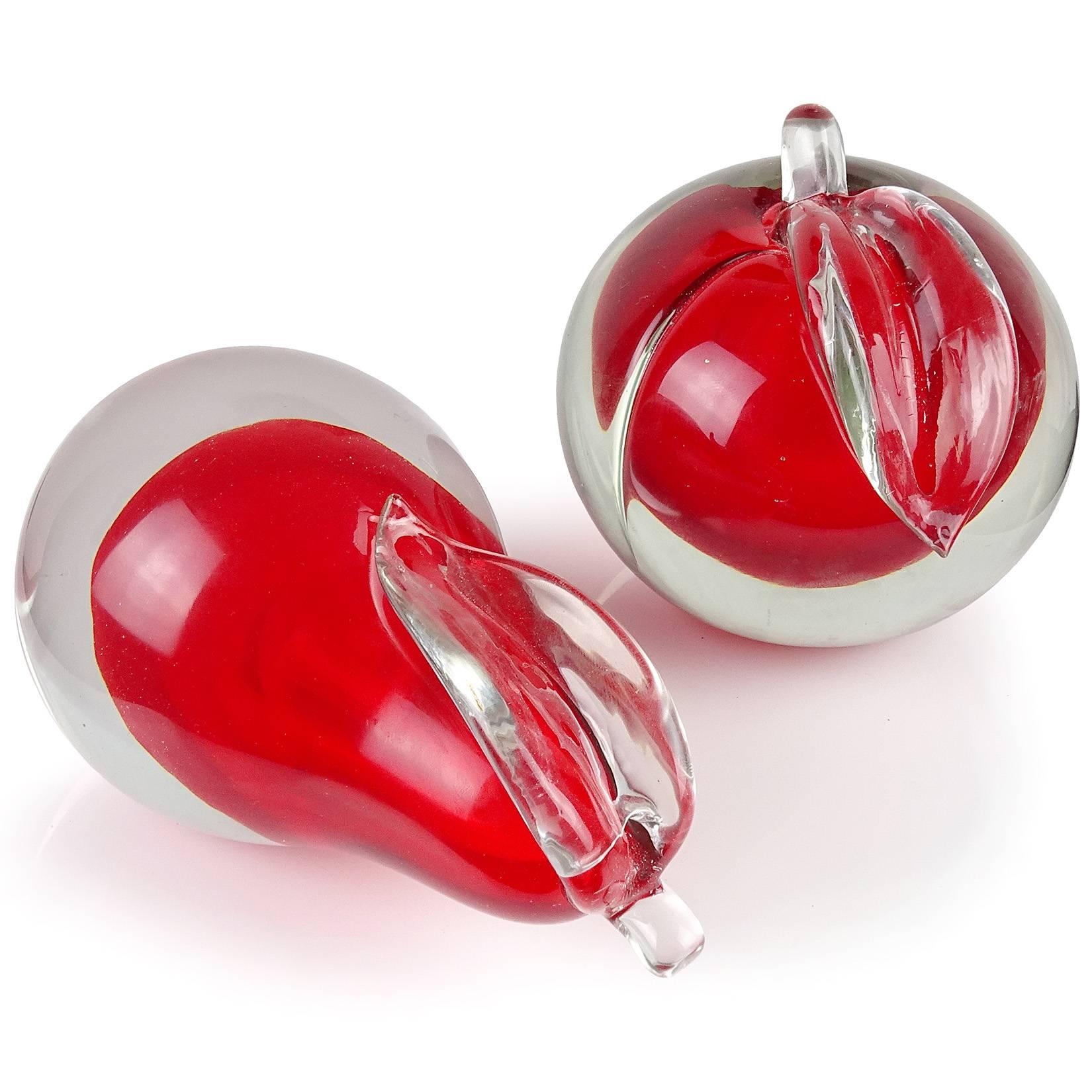 Beautiful Murano handblown Sommerso red Italian art glass pear and apple fruit bookends. Documented to designer Alfredo Barbini. The pieces have two polished ends, so they can be displayed on their sides. Pear measures 6 1/4“ tall. Great decorative