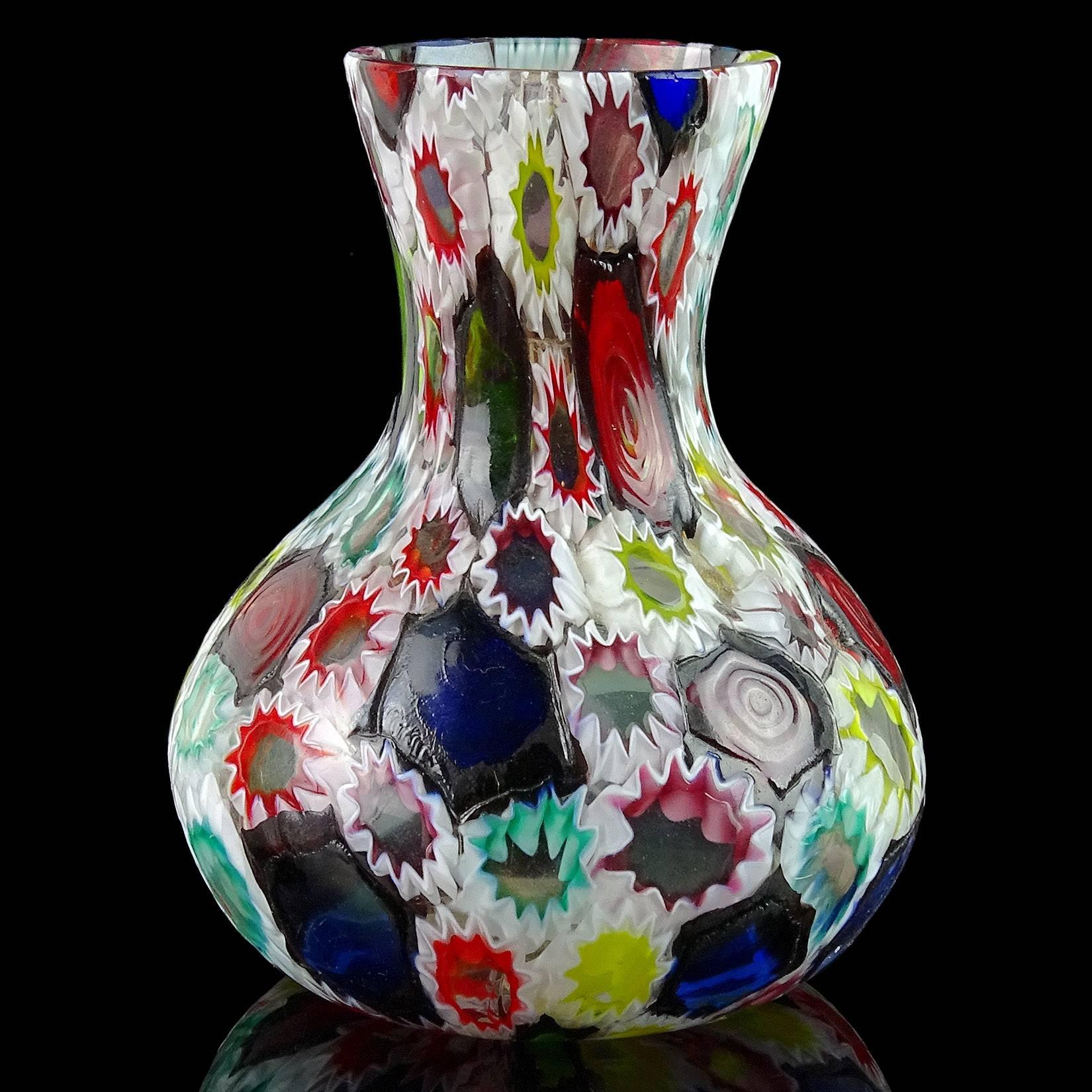 Gorgeous Murano handblown multi-color Millefiori flower and star mosaic Italian art glass flower vase. Documented to the Fratelli Toso company. Many of the murrines are lined in white, while others are lined in metallic black, called 