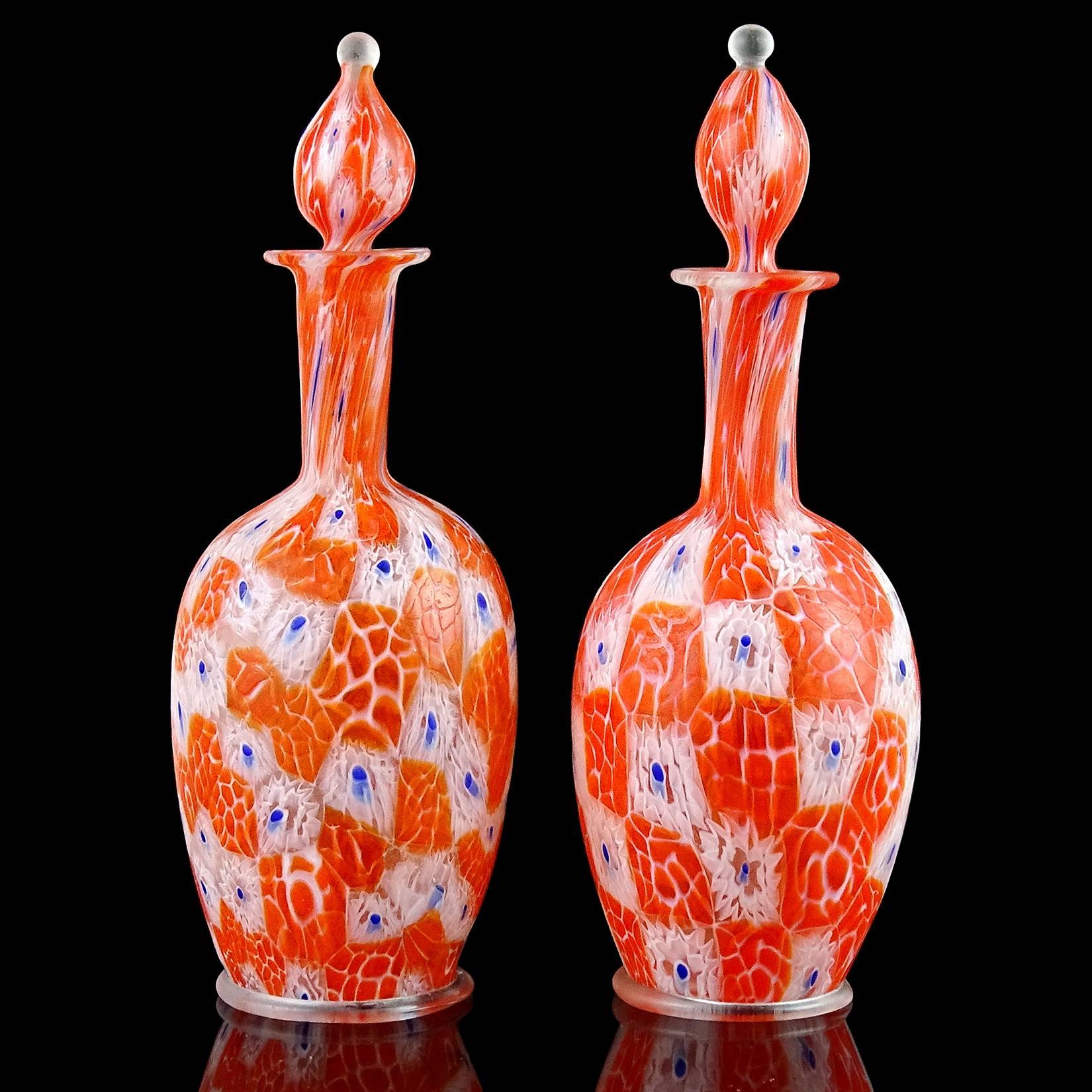 Beautiful antique pair of Murano handblown orange, white, with blue Italian art glass mosaic millefiori flower and beehive murrine perfume bottles. Documented to the Fratelli Toso Company. Each still has their original stoppers, and has a ring