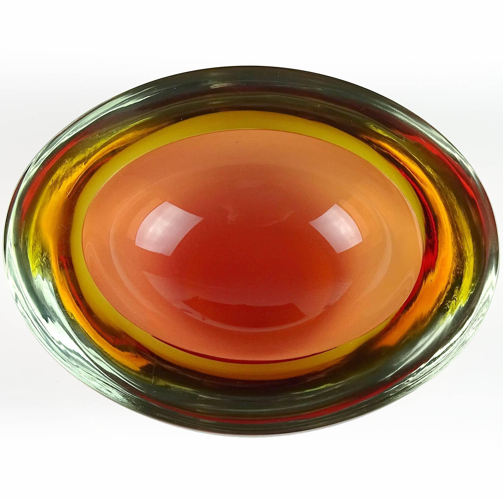 Beautiful Murano handblown Sommerso yellow and peachy orange Italian art glass bowl. Attributed to designer Flavio Poli, for the Seguso Vetri d'Arte company. The piece is very thick and heavy, with an oval shape and flat cut rim. Measures 6 3/4”