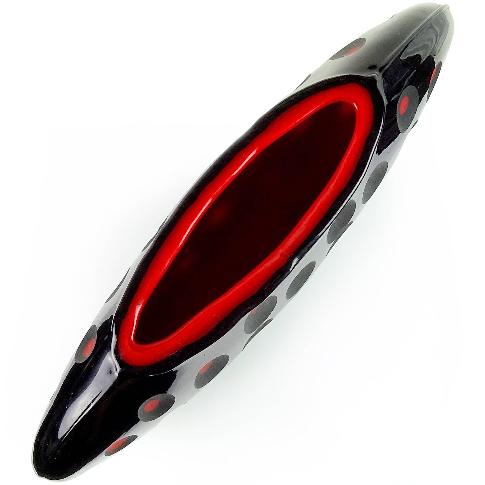 Large modern Murano handblown black over red core Italian art glass sculptural flower vase with carved surface. Created in the manner of the Venini Company. The piece has a flat shape, with carved ovals on both sides, showing the red inside layer.