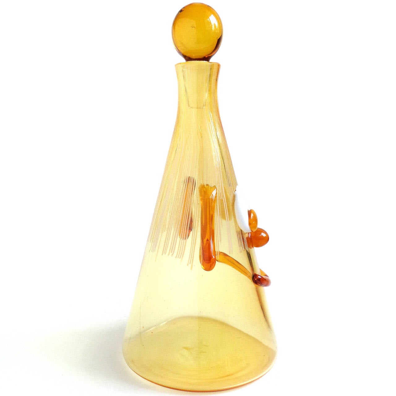 Cute and unusual Murano handblown golden yellow, with applied orange and white Italian art glass clown face decanter. Documented to the Fratelli Toso Company. The piece has droopy ears, wide eyes, a big smile and threads of white glass for the hair.