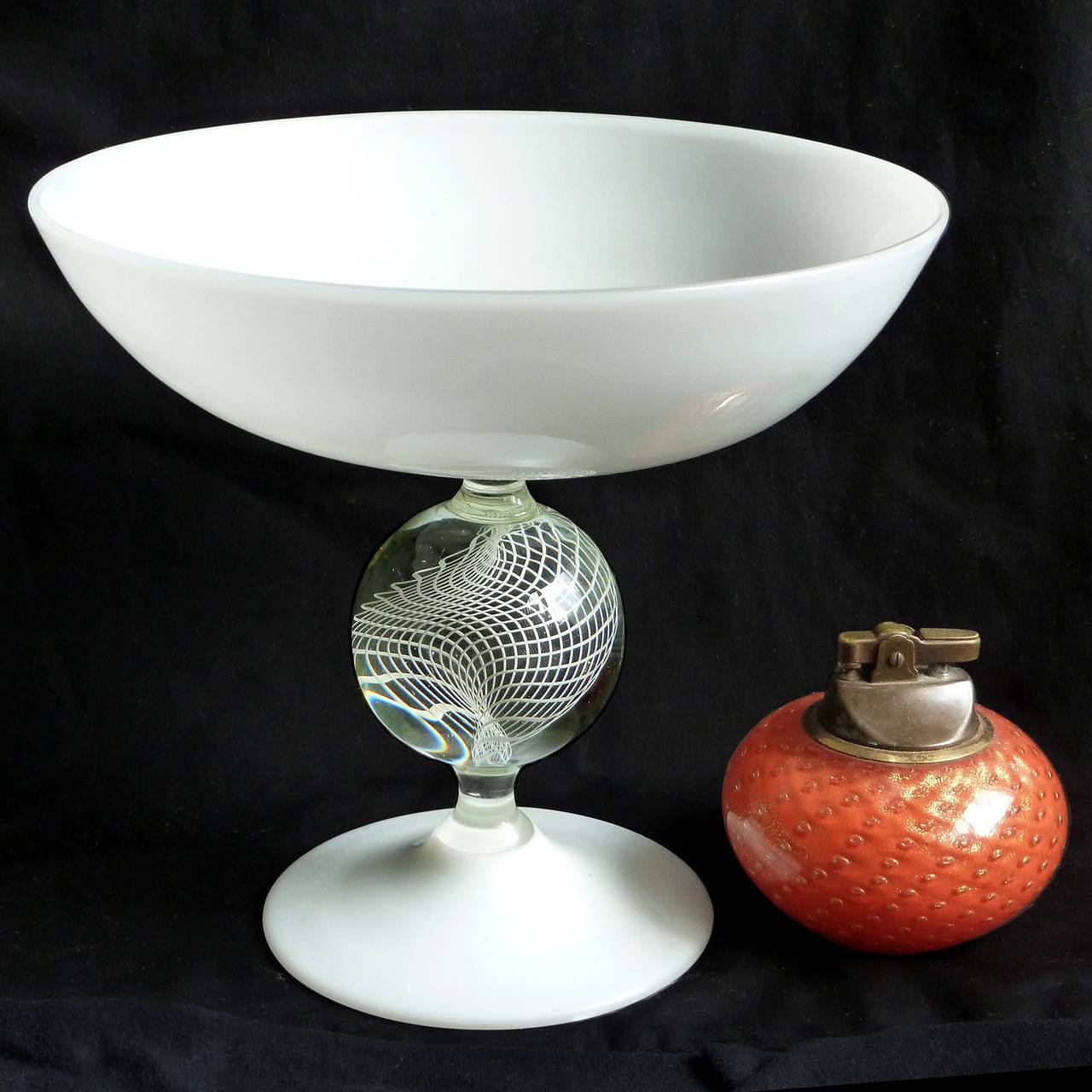Very rare and elegant Murano handblown white Italian art glass compote bowl with Filigrana ribbon ball decoration. Documented to designer Archimede Seguso, circa 1958, and published in his book. The piece is snow white, with a net design centre