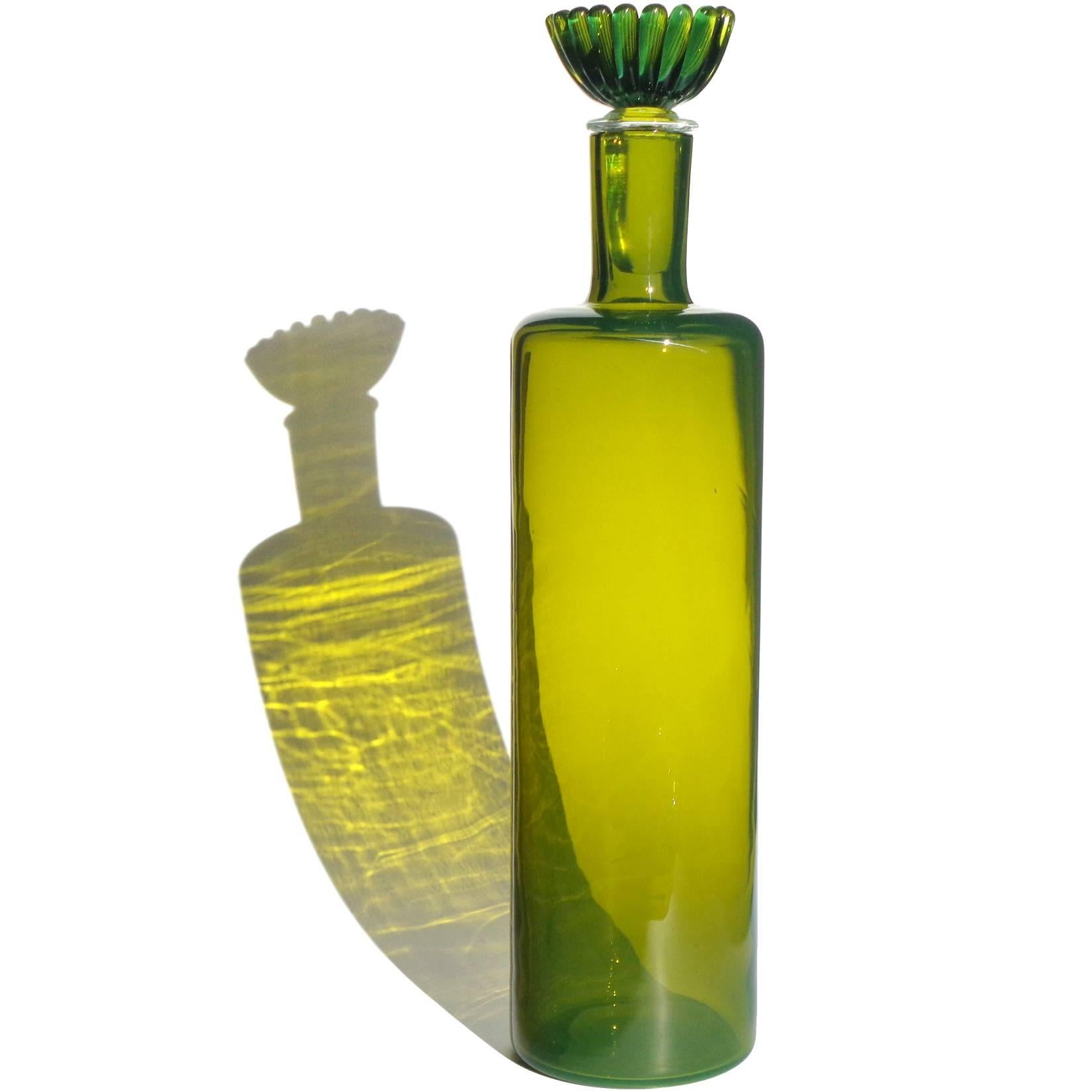 Beautiful large Murano handblown green Italian art glass decanter, with flower stopper. Documented to the Fratelli Toso Company, with original Made In Italy label underneath. Measures: 14 3/4