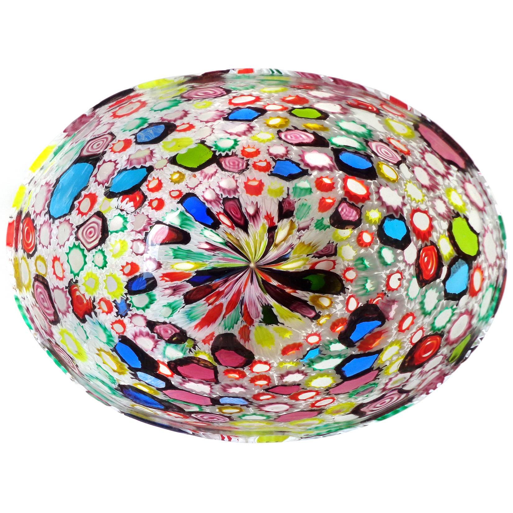 Beautiful Murano handblown multicolor Millefiori flower and star mosaic Italian art glass oval bowl. Documented to the Fratelli Toso Company. Many of the murrines are lined in white, and some are lined in a metallic black. Could be used as a vase as