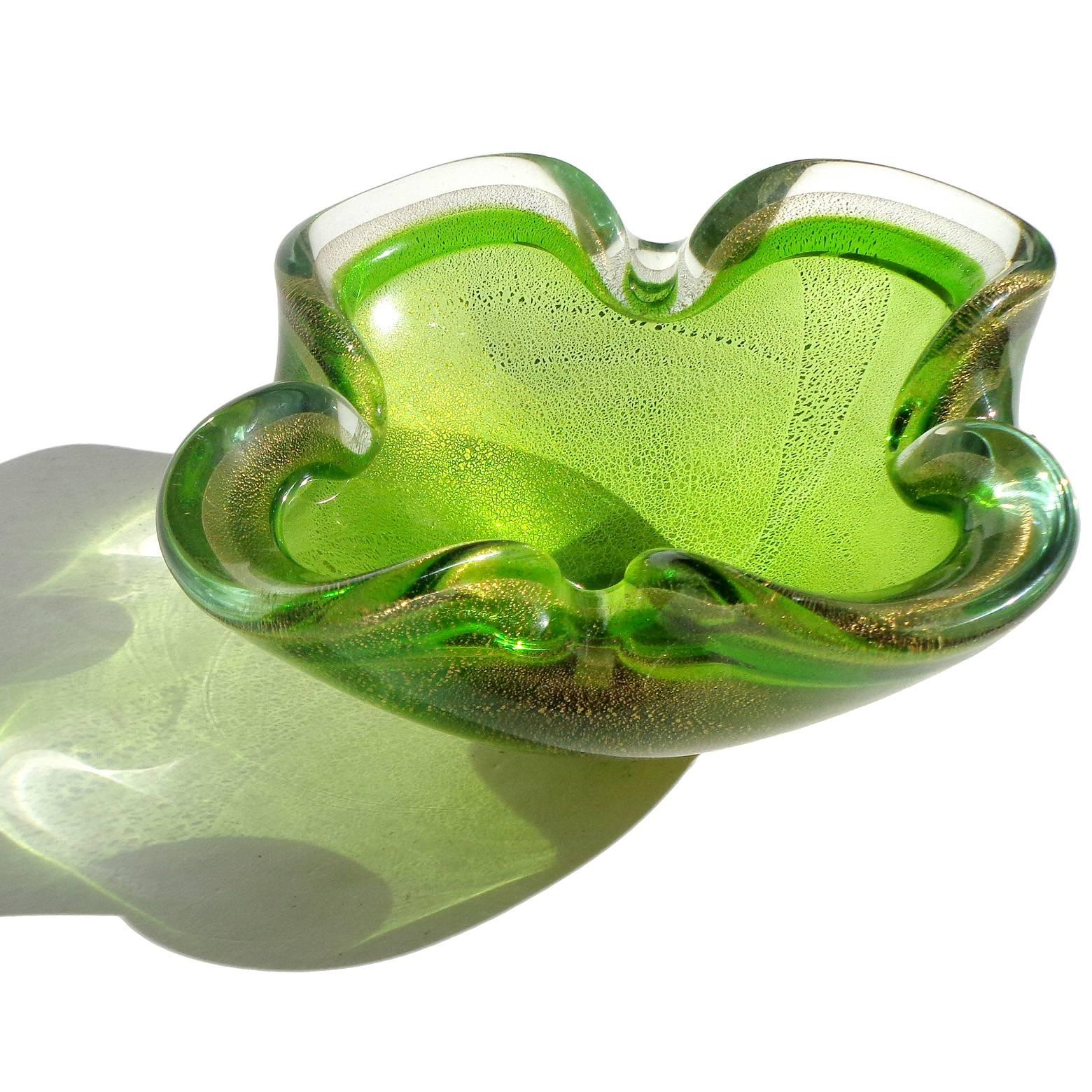 Beautiful Murano handblown Sommerso green and gold flecks Italian art glass bowl. In the manner of designer Archimede Seguso. The piece has a folded in rim, and could be used as an ashtray. Measures: 5 3/4