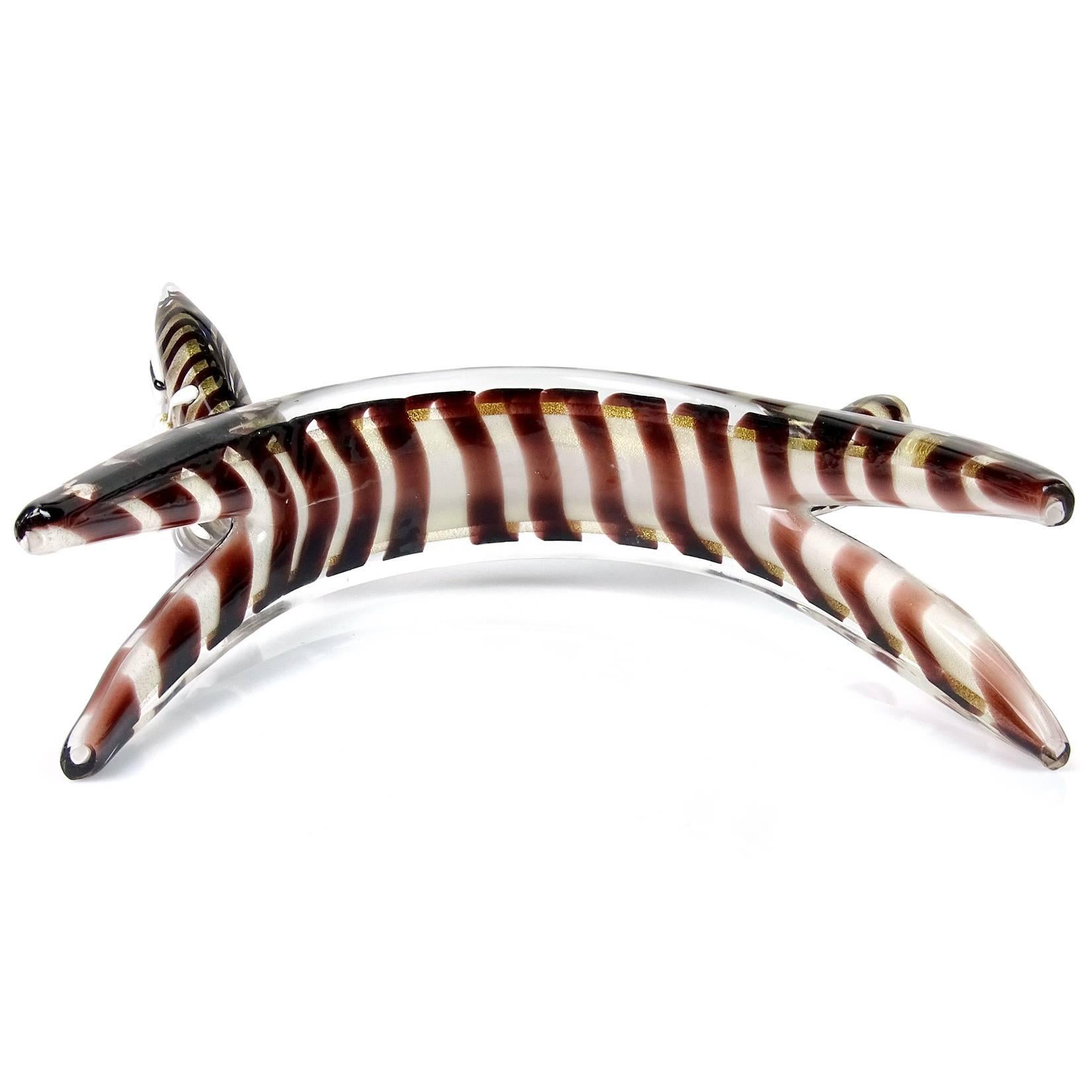 Rare and cute Murano handblown white, gold flecks tiger striped kitty cat Italian art glass sculpture. It has a flattened out shape, with applied eyes and whiskers. Looks like it is scared or just stretching. Measures: 10