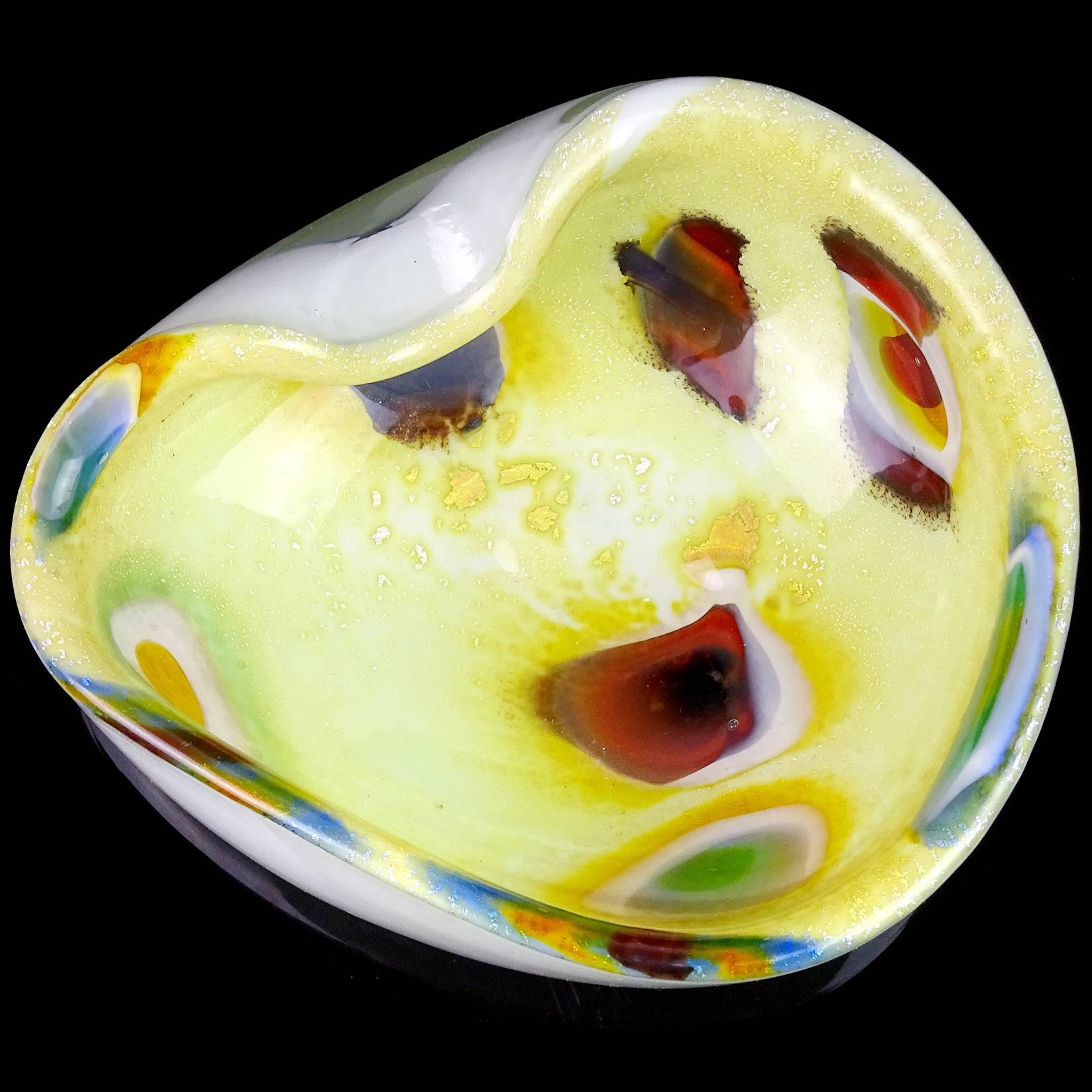 Beautiful Murano handblown white with silver flecks, yellow and peacock eye murrines Italian art glass bowl. The piece has a creamy yellow color, with decorative fold on the rim. Measures: 6 1/2