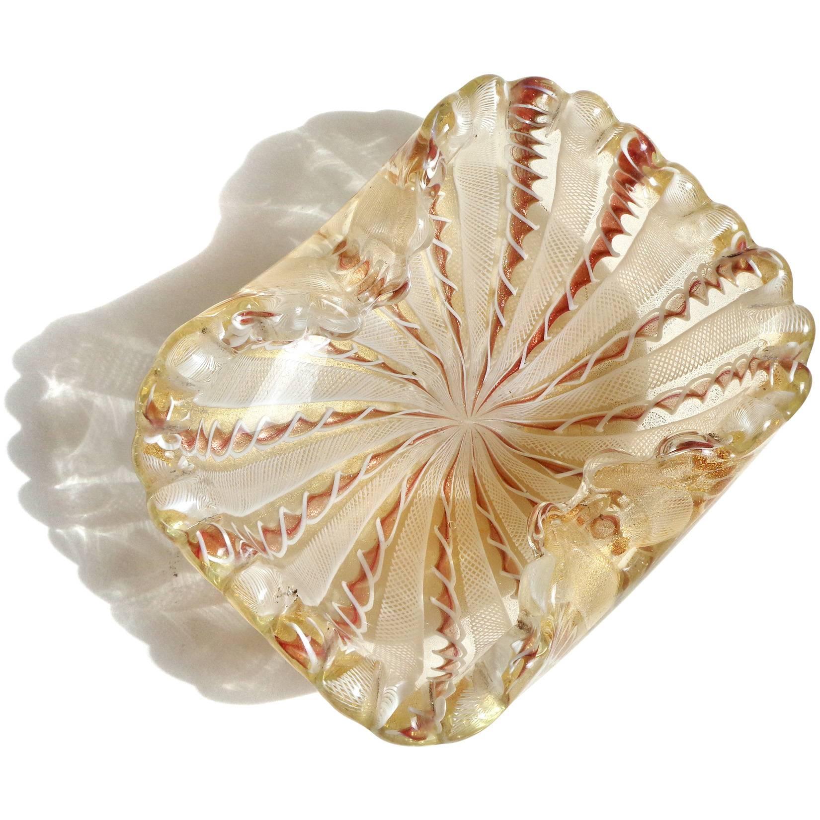 Beautiful Murano handblown copper aventurine ribbons, white netting and gold flecks art glass decorative bowl. Documented to the Fratelli Toso company. The piece has a scalloped rim, Zanfirico and twisted Latticino ribbons. Profusely covered in gold