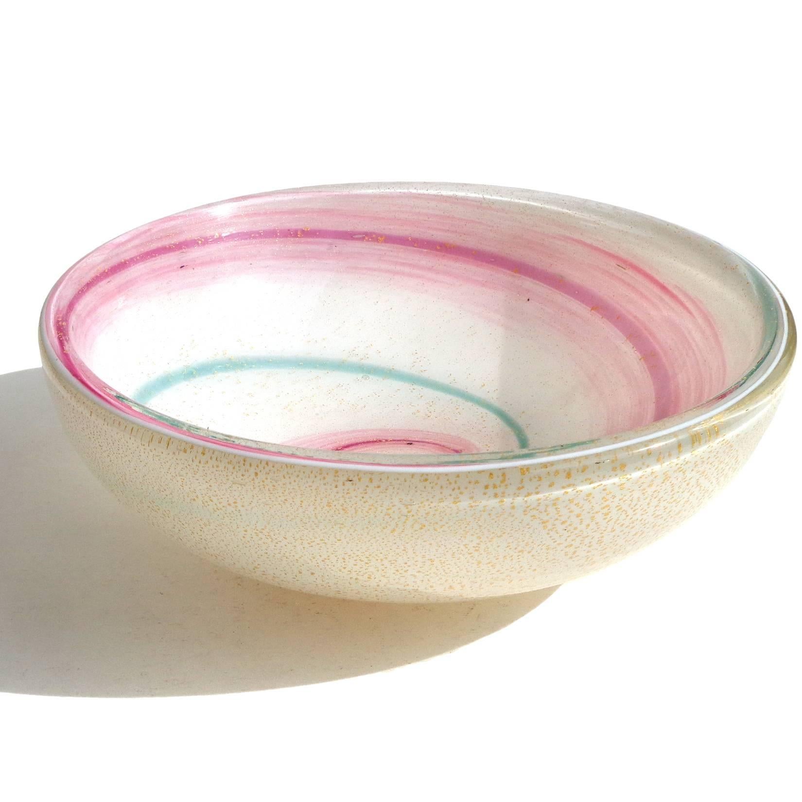 Beautiful Murano hand blown white, gold flecks, pink and aqua green swirl Italian art glass bowl. The piece is covered inside and out with heavy gold leaf. Still retains a partial label underneath, with 