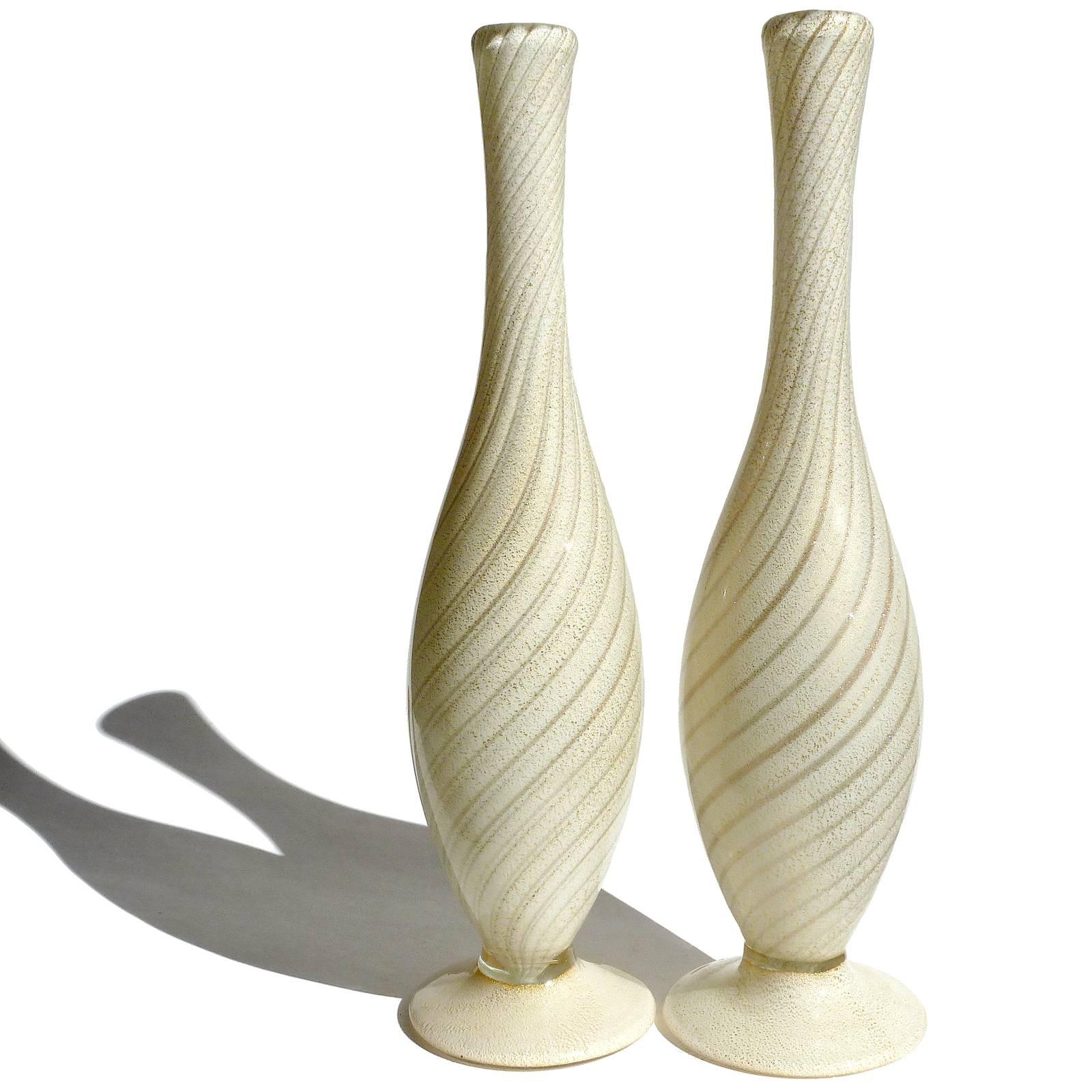 Beautiful pair of Murano hand blown white, gold and swirling aventurine fleck stripes Italian art glass flower vases. Documented to designer Alfredo Barbini, circa 1950s. Very elegant shape, each with applied foot, and profusely covered in gold
