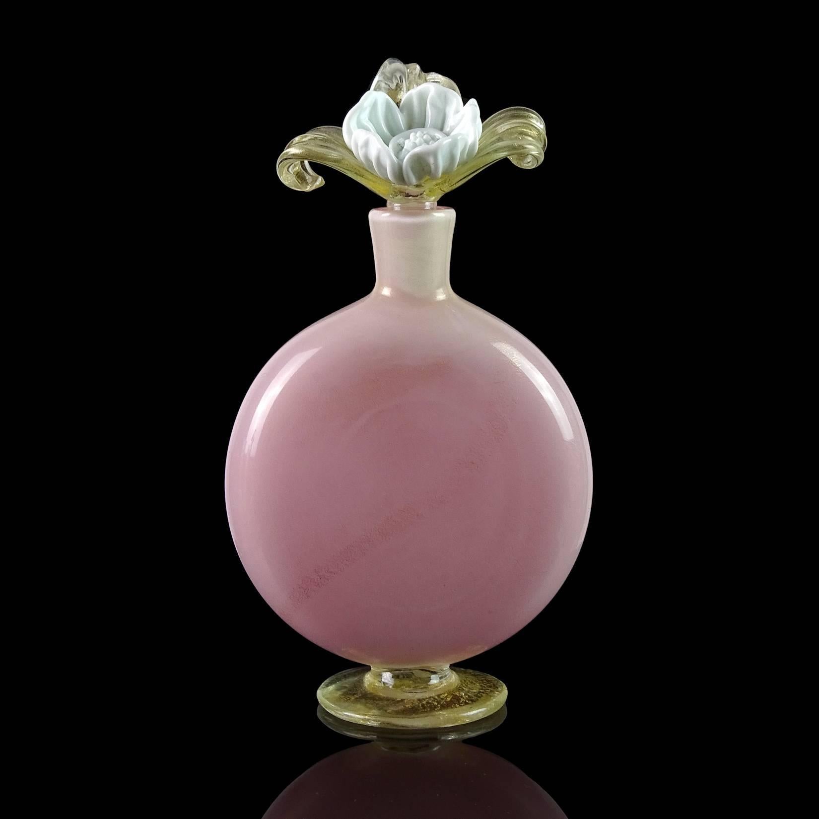Gorgeous large Murano hand blown incamiciato pink and gold flecks Italian art glass perfume bottle with large flower stopper. Created in the manner of designer Tomaso Buzzi. For accuracy, the stopper has some impact marks to the bottom of it (see