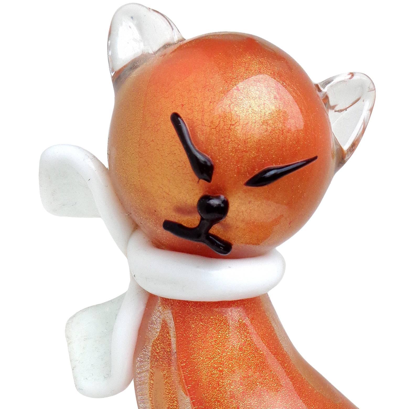 Gorgeous Murano hand blown orange and gold flecks Italian art glass cat figurine or sculpture with white bow. Documented to designer Alfredo Barbini, circa 1950s. It is published in his catalog. The kitten has a very elegant shape, with black