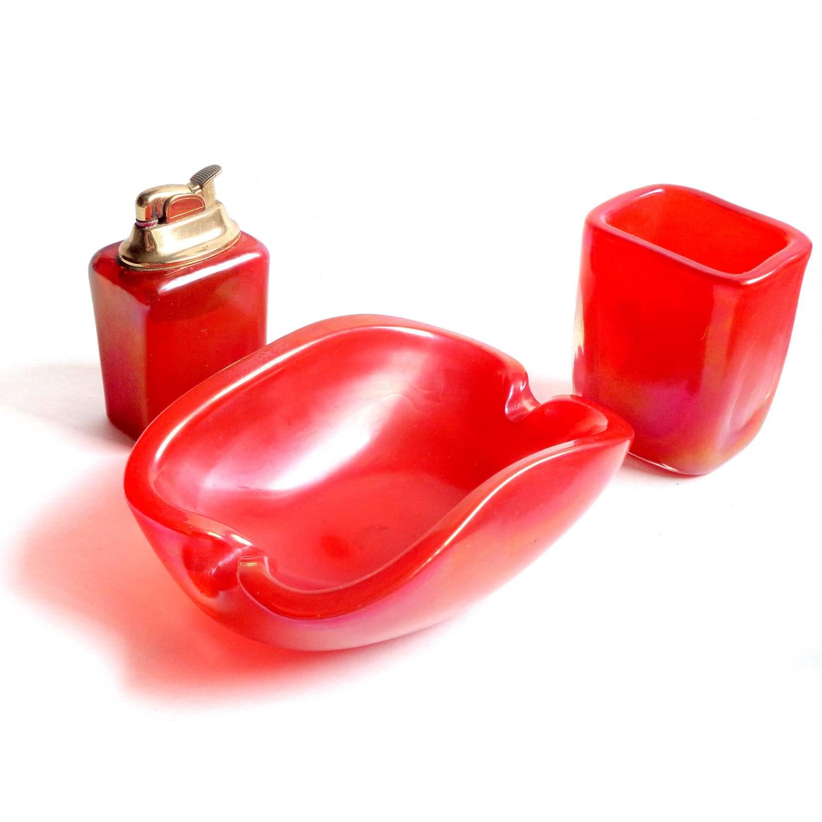FREE Shipping Worldwide! See details below description.

Bright Murano hand blown iridescent orange art glass bowl, lighter and cigarette holder set. Documented to the Fratelli Toso company. The pieces shimmer with a rainbow of colors as the light