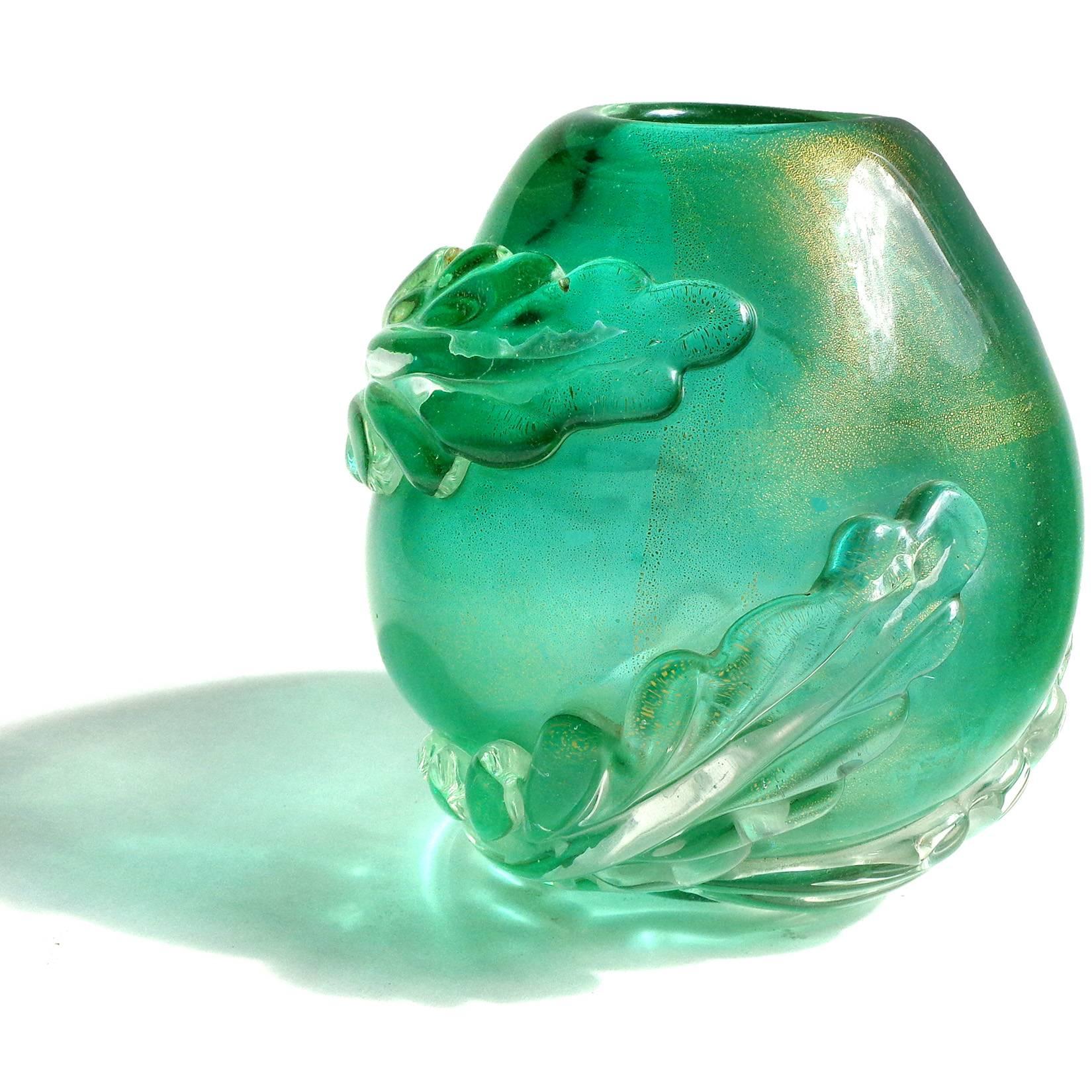 Free shipping worldwide! See details below description.

Rare Murano handblown green and gold flecks art glass egg shaped flower vase with 3 large applied leafs. Attributed to the Seguso Vetri d'Arte company. The piece is very heavy, and profusely