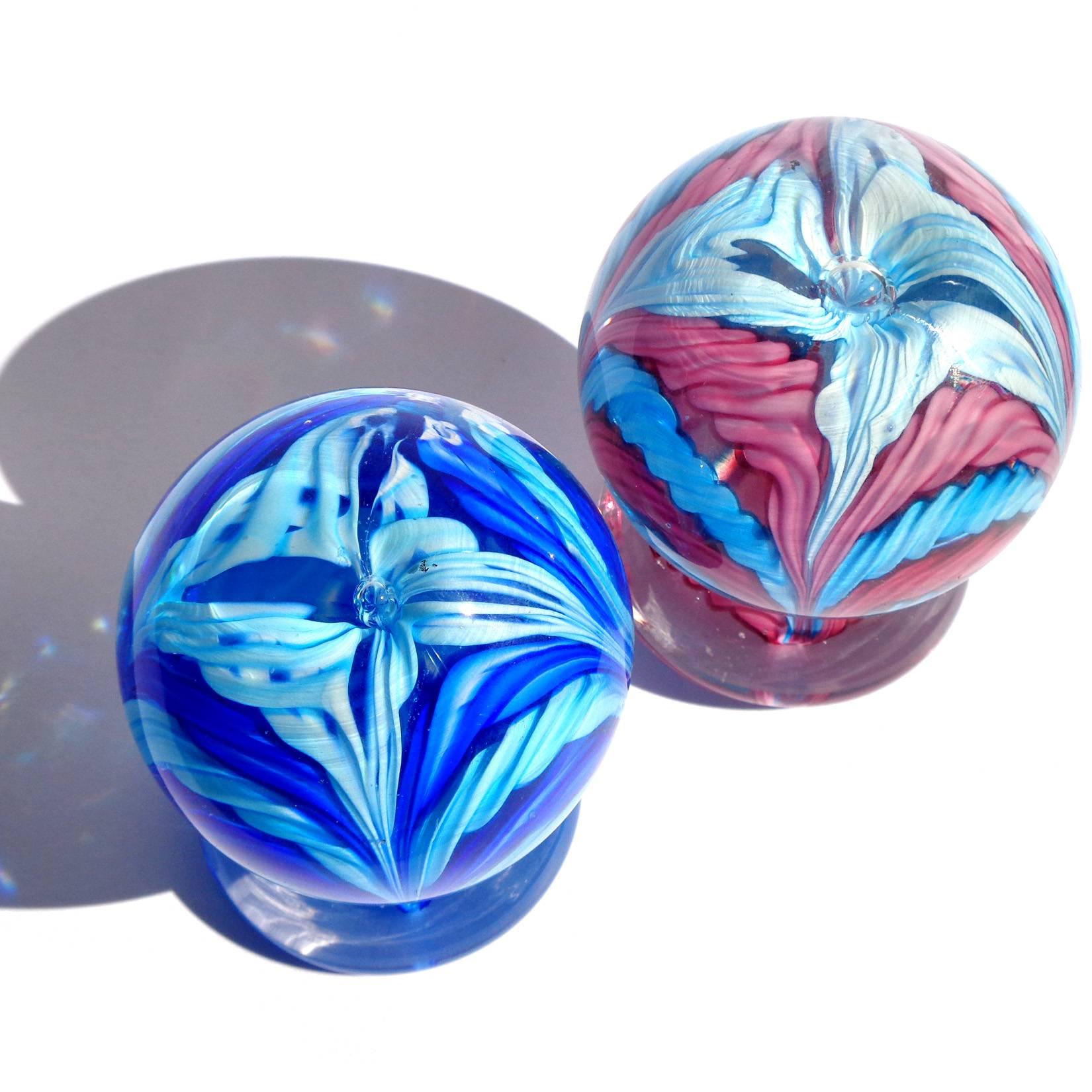 Beautiful, and colorful set of Murano hand blown twisted cotton candy ribbon Italian art glass paperweights. Documented to the Fratelli Toso company. One still retains its original import label. They measure 4" tall x 3" wide. 
