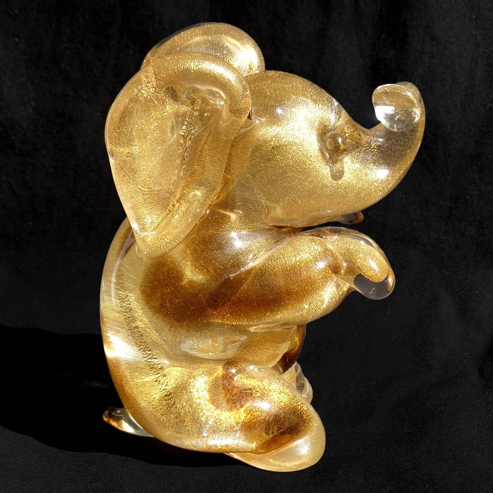 Free shipping worldwide! See details below description.

Adorable Murano handblown gold flecks and amber spots art glass baby elephant figure. Documented to designer Archimede Seguso, with 