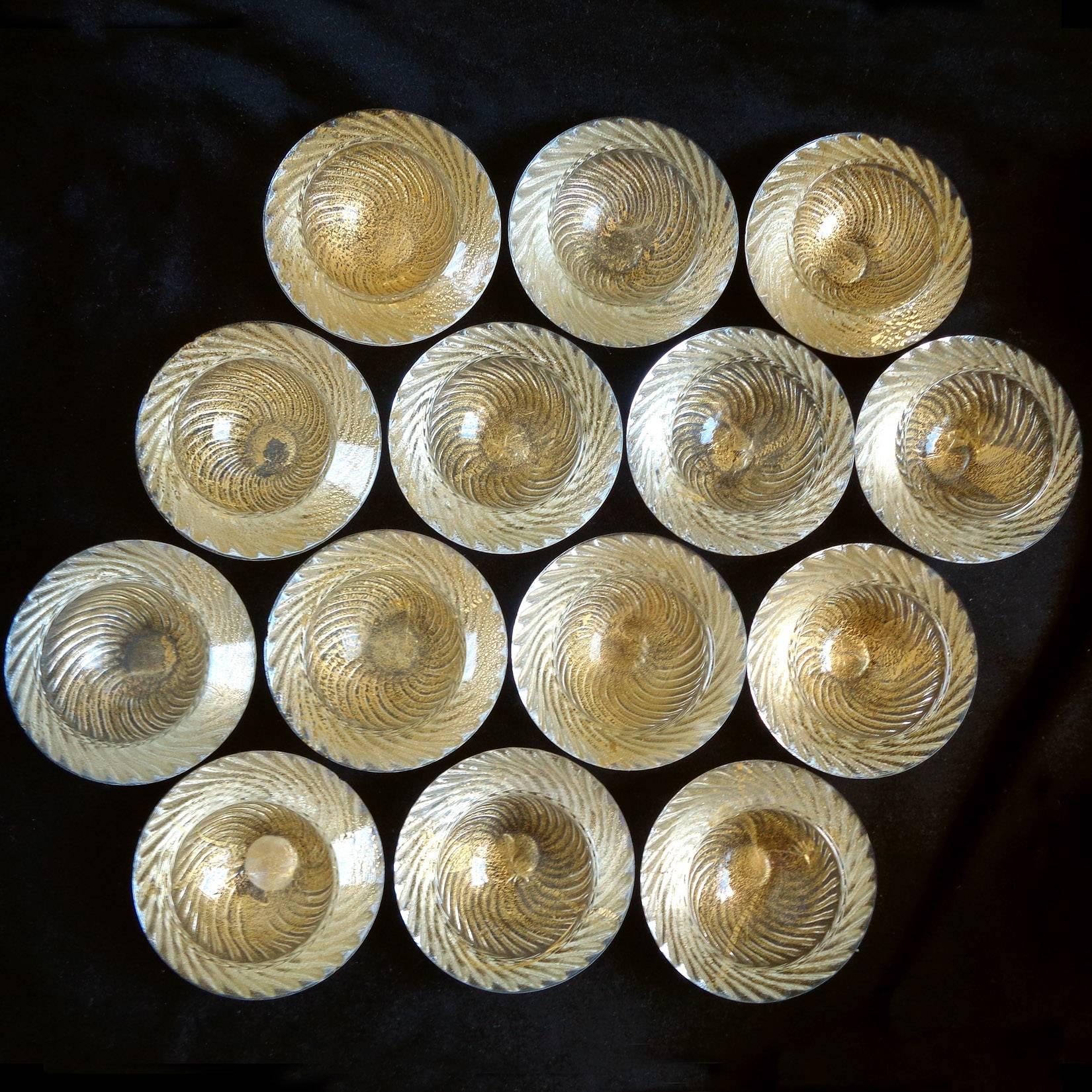 Beautiful set of 14 Murano clear and gold flecks, ribbed pattern round Italian art glass salt dishes. Created in the manner of Seguso Vetri D' Arte and Salviati companies. These are from the 1950s, from the Camer Glass Gallery. They measure close to