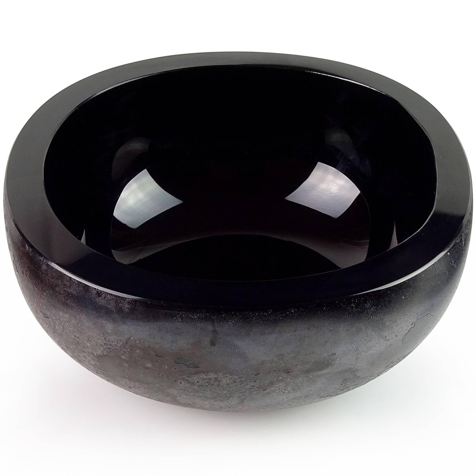 Beautiful large Murano handblown jet black Italian art glass centerpiece bowl with “Scavo” lava surface texture and slight iridescence. Documented, and signed by designer Alfredo Barbini, for Oggetti. It is also numbered. Measures 7 3/8” across x 3