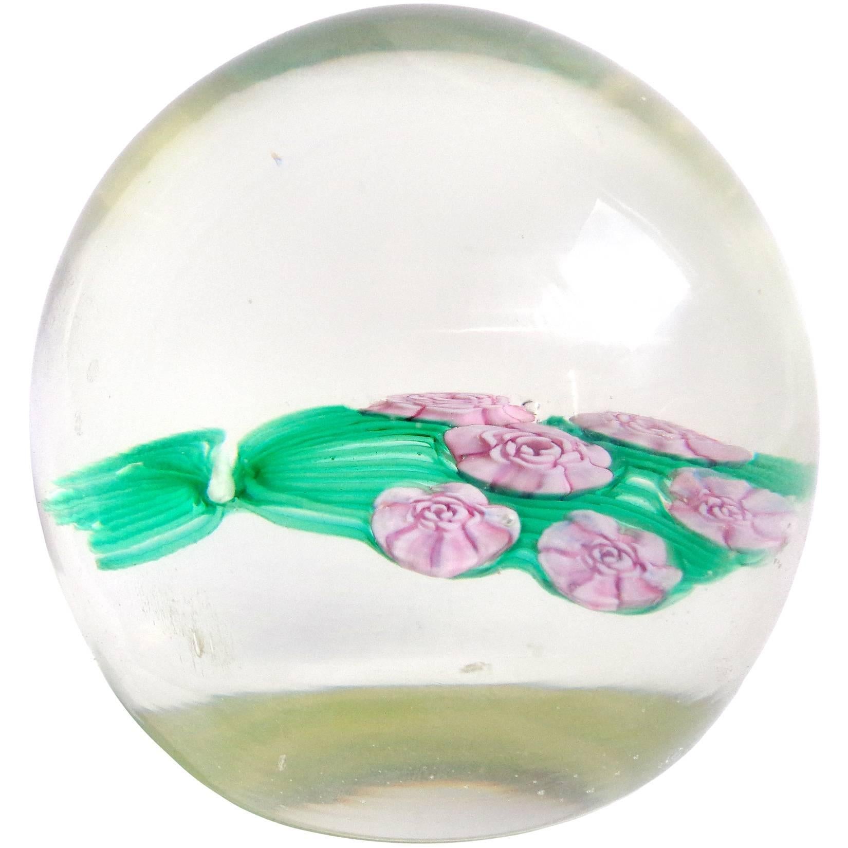 Beautiful set of Murano handblown flower design Italian art glass paperweights. Documented to the Fratelli Toso Company. One is a large pink and lavender spots flower, the second is a flower bouquet made with millefiori roses and third a pair of