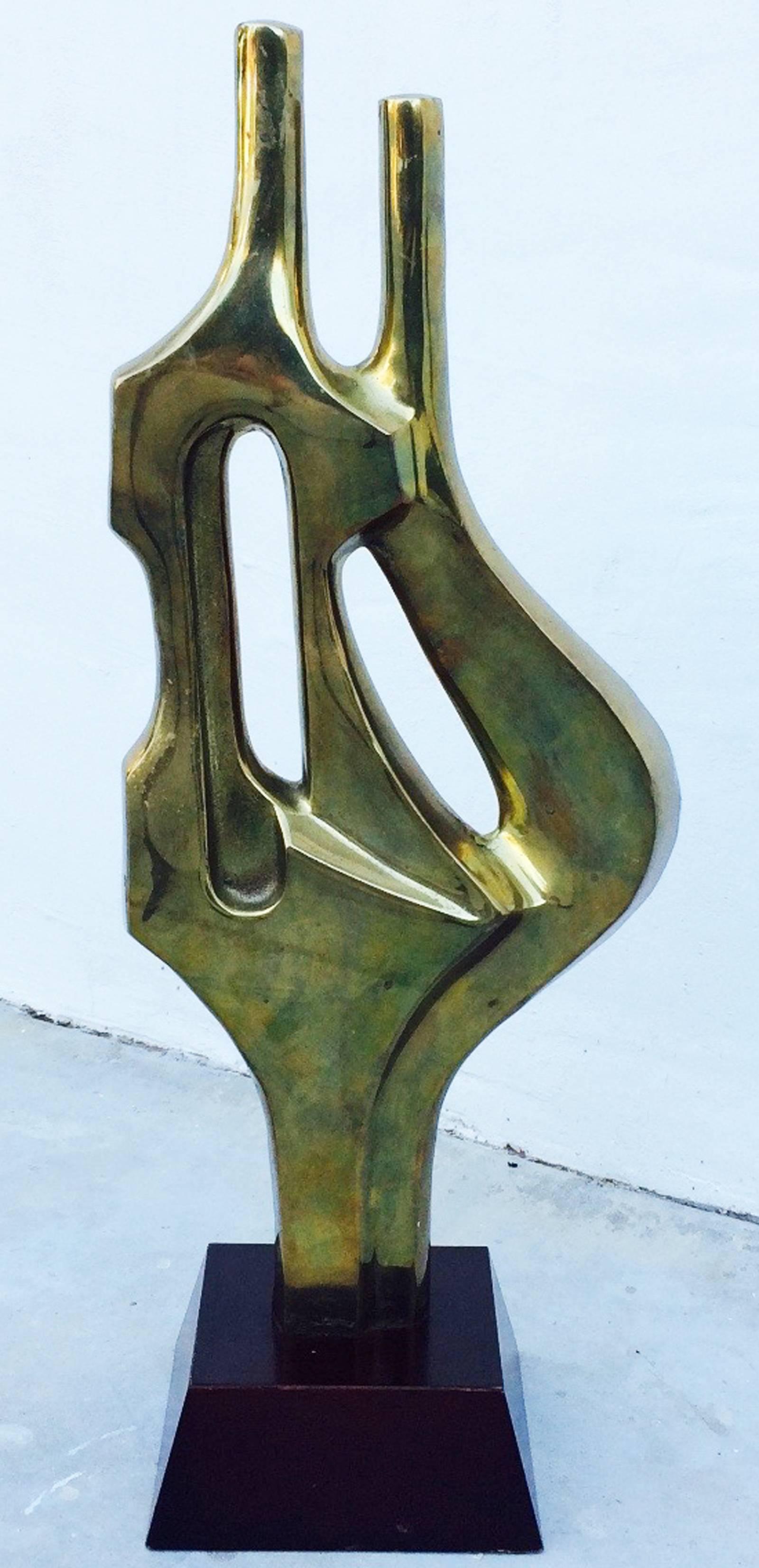 A fine Decorative Crafts sculpted brass item mounted on a ebonized wood Stand. Sculpted fluid item retains original brass finish and patina. Excellent with no issues.